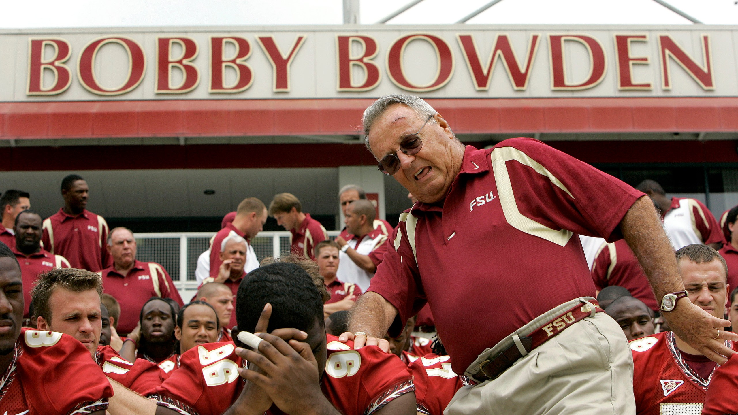 In this Aug. 12, 2007, file photo, Florida State head football coach Bobby Bowden, right, squeezes into his seat for a team photo during media day activities in Tallahassee, Fla. (AP Photo/Phil Coale, File)