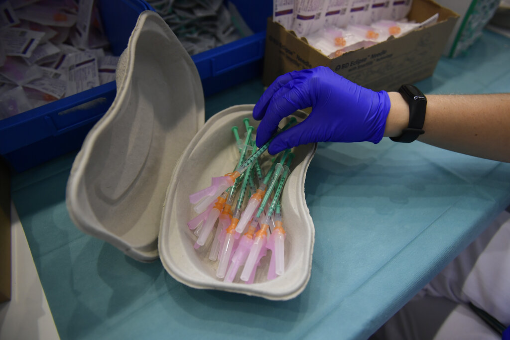 In this Thursday, Sept. 2, 2021 file photo, a health worker prepares Pfizer vaccines during the national COVID-19 vaccination campaign in Pamplona, northern Spain. (AP Photo/Alvaro Barrientos, File)