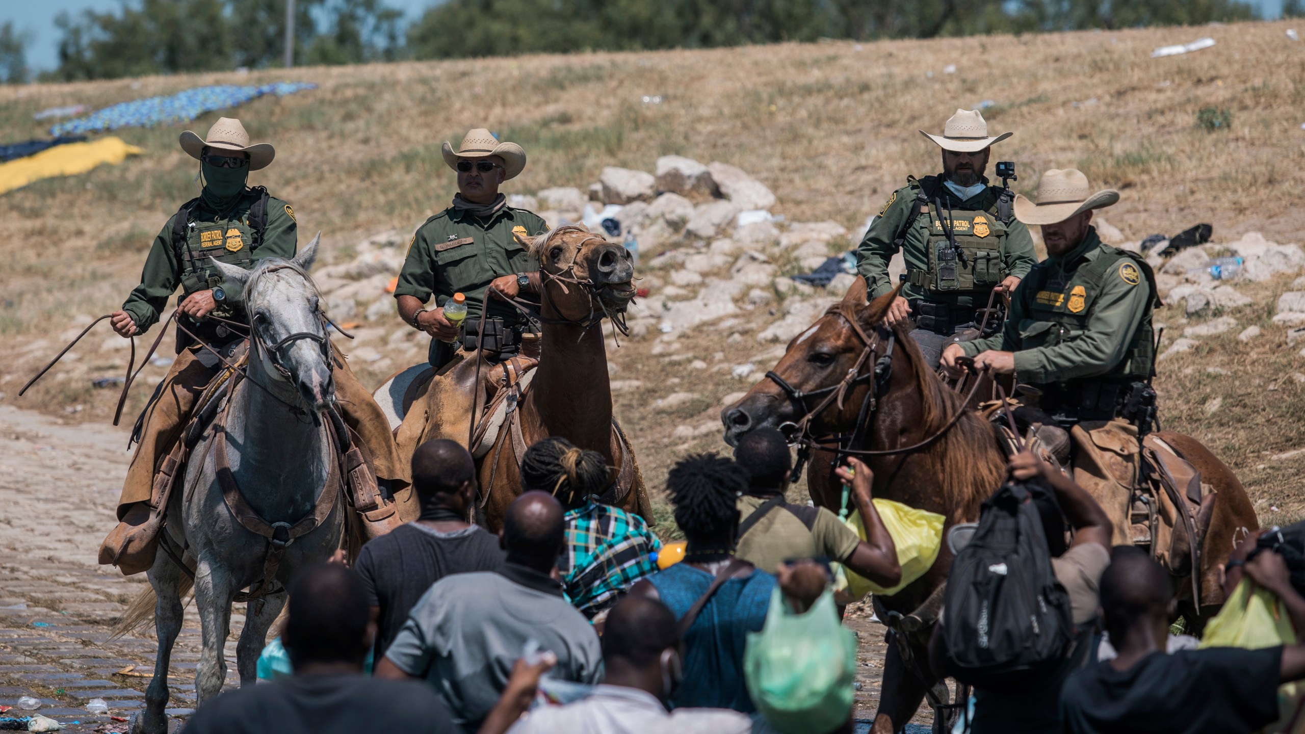 U.S. Customs and Border Protection mounted officers attempt to contain migrants as they cross the Rio Grande from Ciudad Acuña, Mexico, into Del Rio, Texas, Sunday, Sept. 19, 2021. Thousands of Haitian migrants have been arriving to Del Rio, Texas, as authorities attempt to close the border to stop the flow of migrants. (AP Photo/Felix Marquez)