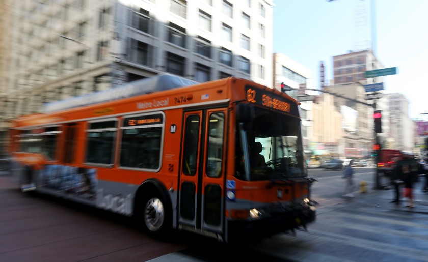 A bus motors down Third Street in downtown Los Angeles in the file photo. (Los Angeles Times)