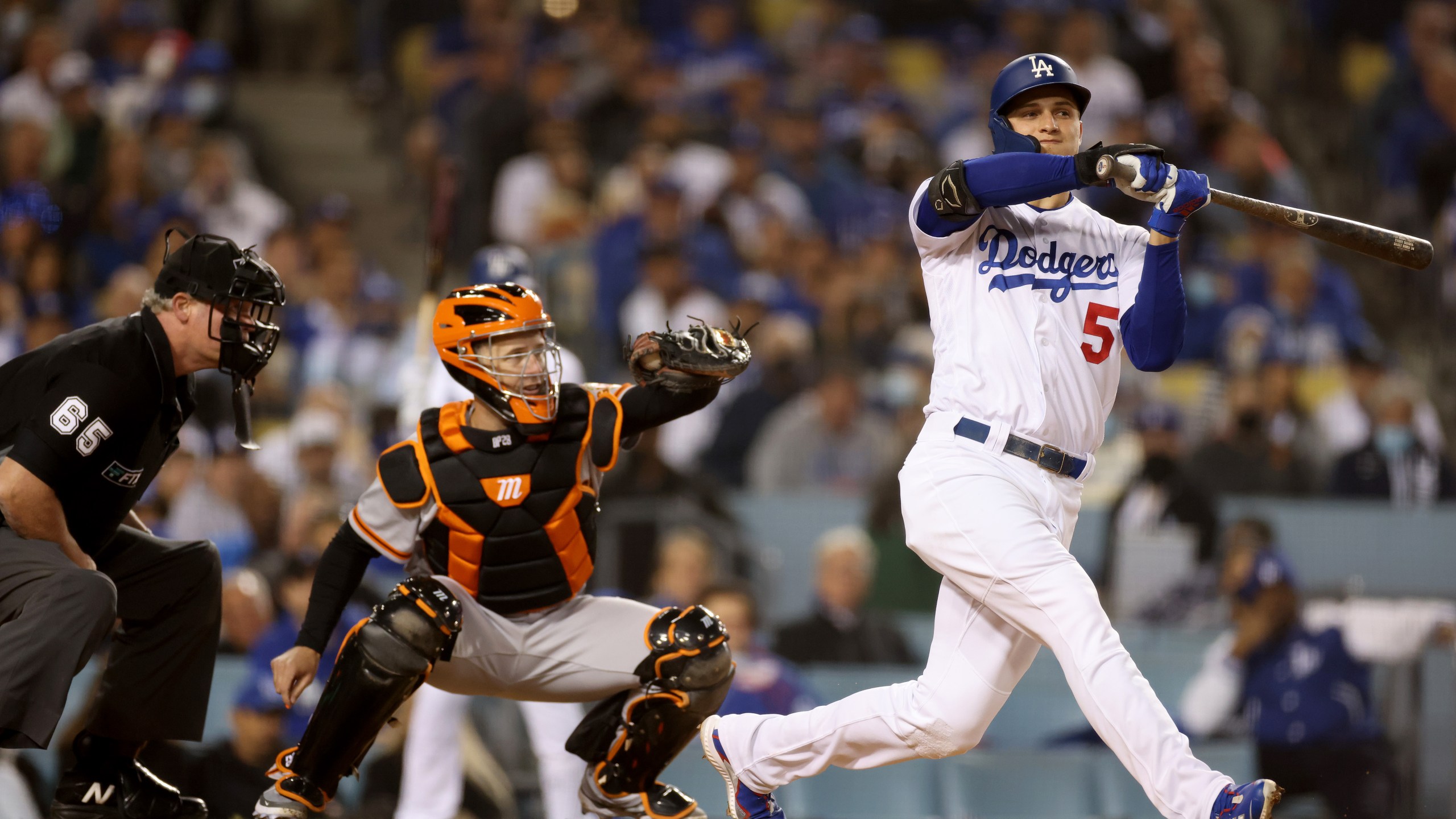 Corey Seager #5 of the Los Angeles Dodgers checks his swing allowing for a walk in front of Buster Posey #28 of the San Francisco Giants during the fourth inning in game 3 of the National League Division Series at Dodger Stadium on Oct. 11, 2021, in Los Angeles, California. (Harry How/Getty Images)