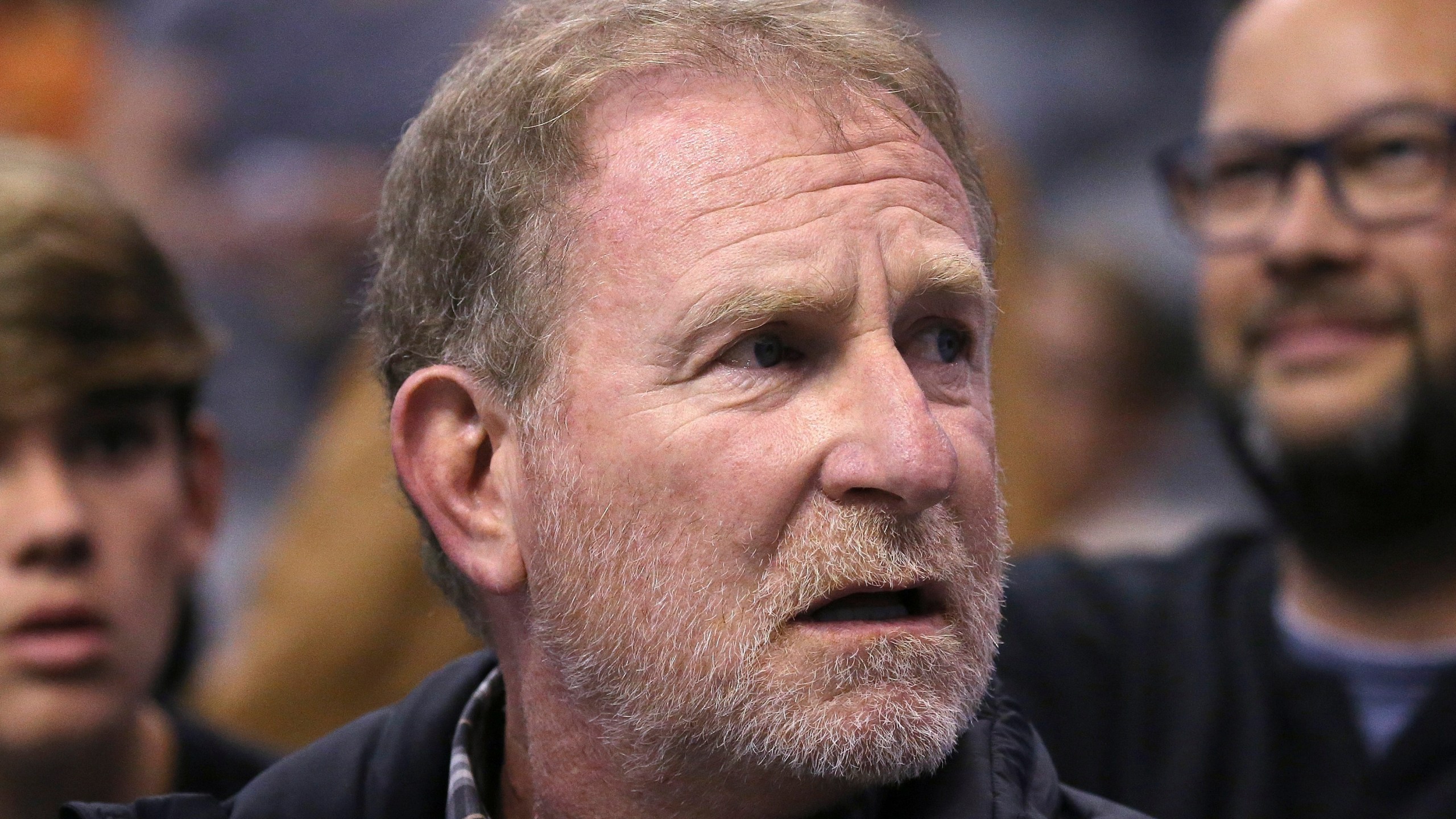 In this Dec. 11, 2019, file photo, Phoenix Suns owner Robert Sarver watches the team play against the Memphis Grizzlies during the second half of an NBA basketball game in Phoenix. The Suns released a statement regarding a potential media investigation into the workplace culture of the franchise, denying that the organization or Sarver has a history of racism or sexism. The statement sent Friday, Oct. 22, 2021, said the organization is aware that ESPN is working on a story accusing the organization of misconduct on a “variety of topics.” The Suns responded by saying they were “completely baseless claims” and “documentary evidence in our possession and eyewitness accounts directly contradict the reporter’s accusations, and we are preparing our response to his questions.” (AP Photo/Ross D. Franklin)