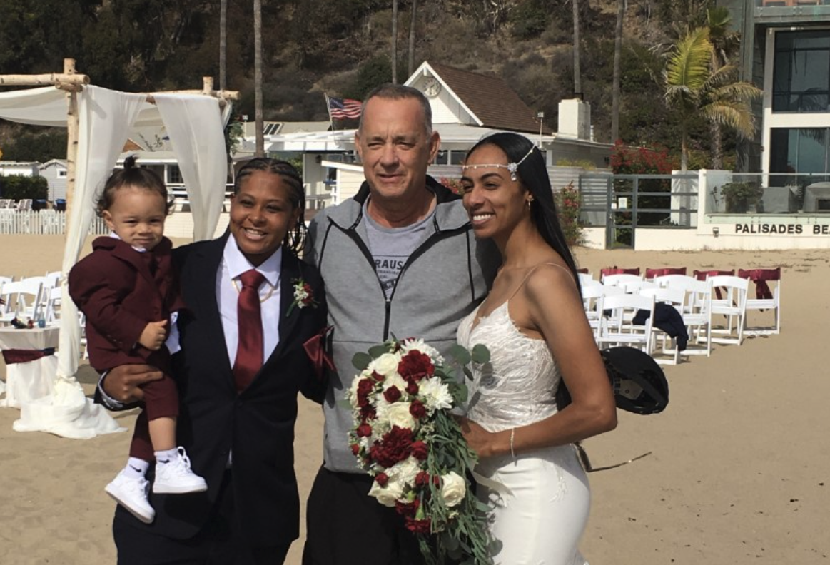 Tom Hanks poses with brides Tashia and Diciembre Farries on their wedding day in Santa Monica in October 2021. (Courtesy of Tashia and Diciembre Farries)