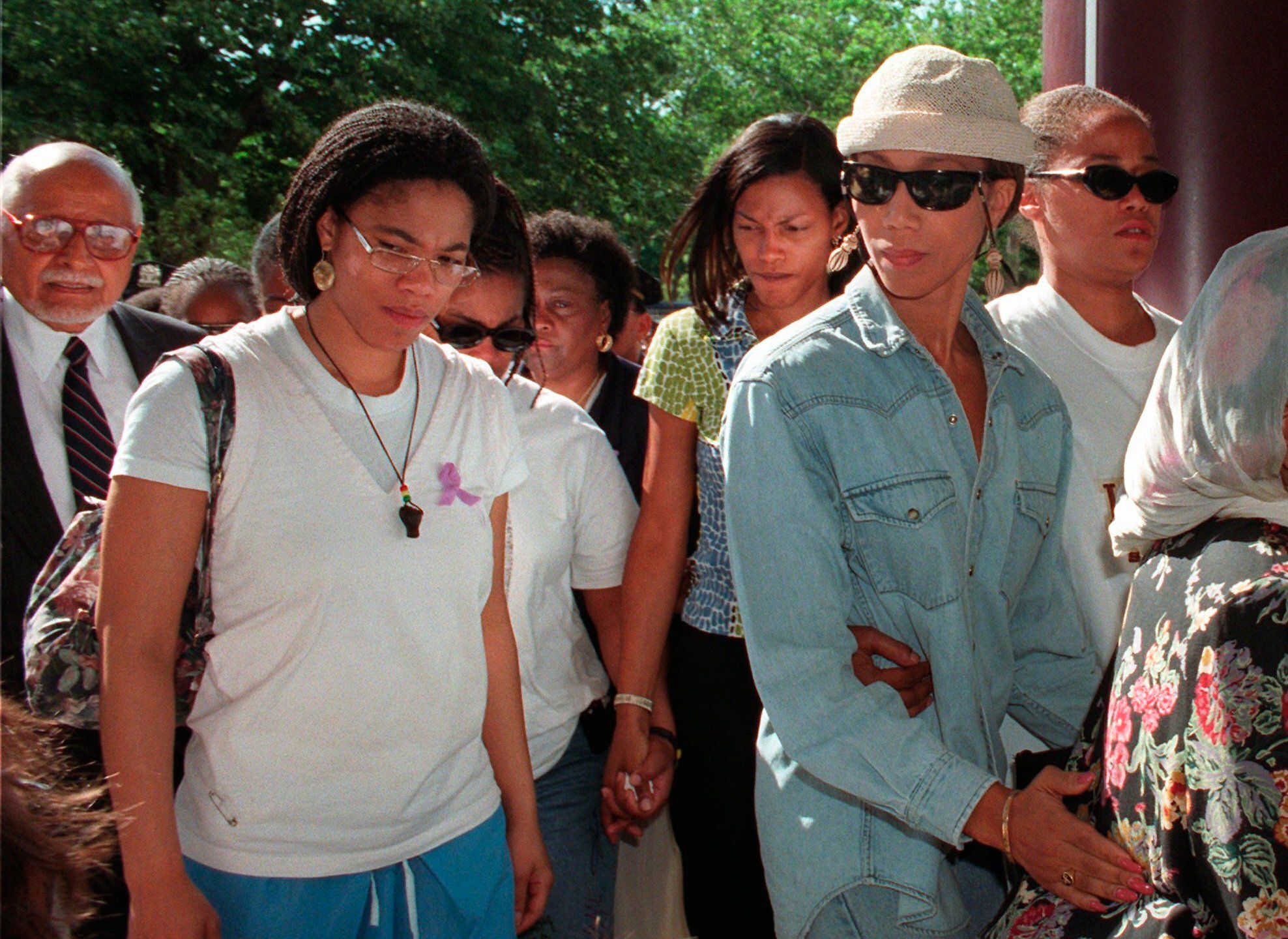 Malikah Shabazz, left, daughter of Malcolm X, walks with her sisters, Ilyasah, third from right, Attallah, second from right, and Malaak, after talking to the media following the death of their mother Betty Shabazz, June 23, 1997 in New York. Malikah Shabazz, was found dead in her home in New York City from what appeared to be natural causes, police said Tuesday, Nov. 23, 2021. She was 56. (AP Photo/Ron Frehm, File)