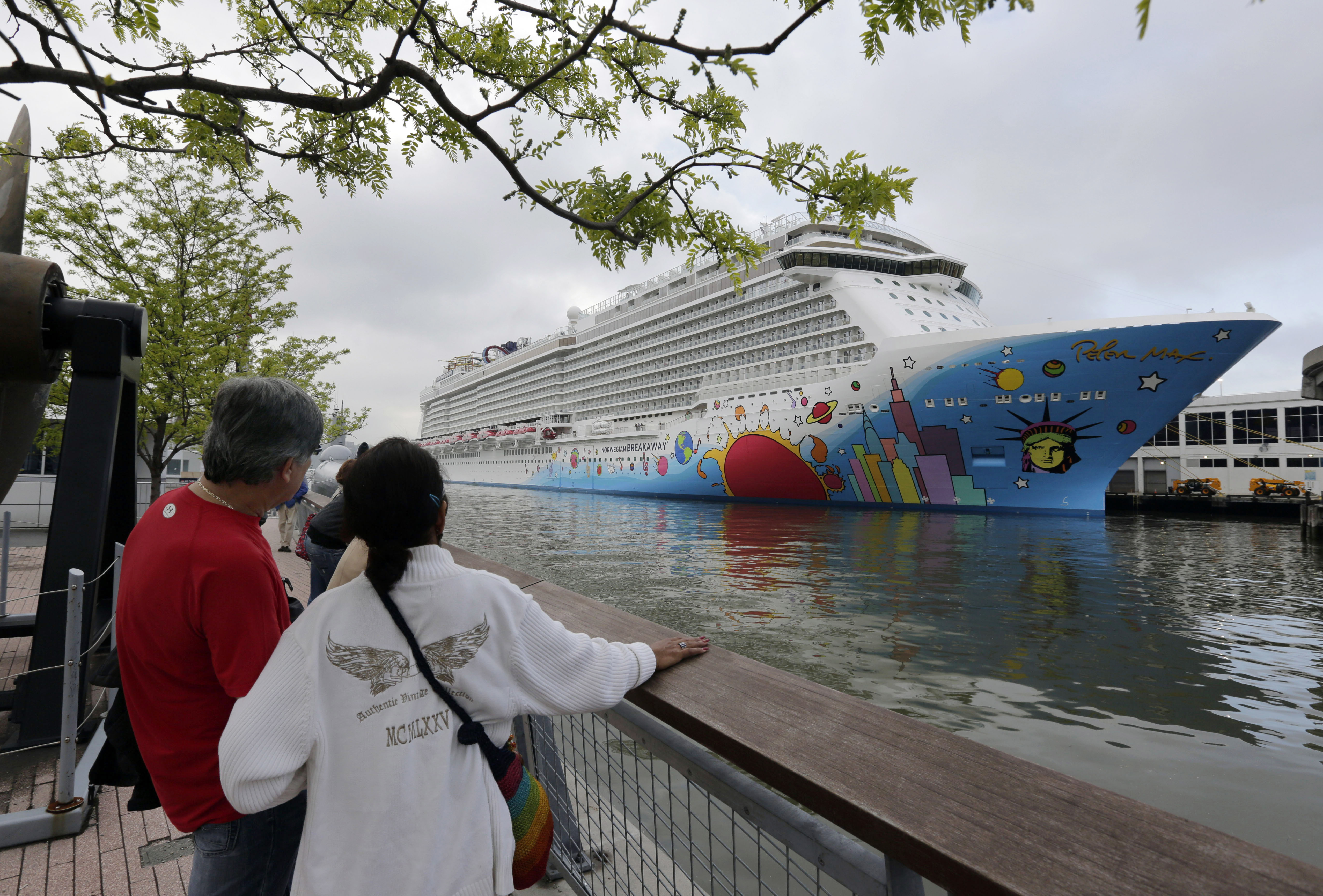 People pause to look at Norwegian Cruise Line's ship, Norwegian Breakaway, on the Hudson River, in New York, on May 8, 2013. Ten people aboard the cruise ship, approaching New Orleans, have tested positive for COVID-19, officials said Saturday night, Dec. 4, 2021. The Norwegian Breakaway had departed New Orleans on Nov. 28 and is due to return this weekend, the Louisiana Department of Health said in a news release. Over the past week, the ship made stops in Belize, Honduras and Mexico. (AP Photo/Richard Drew, File)