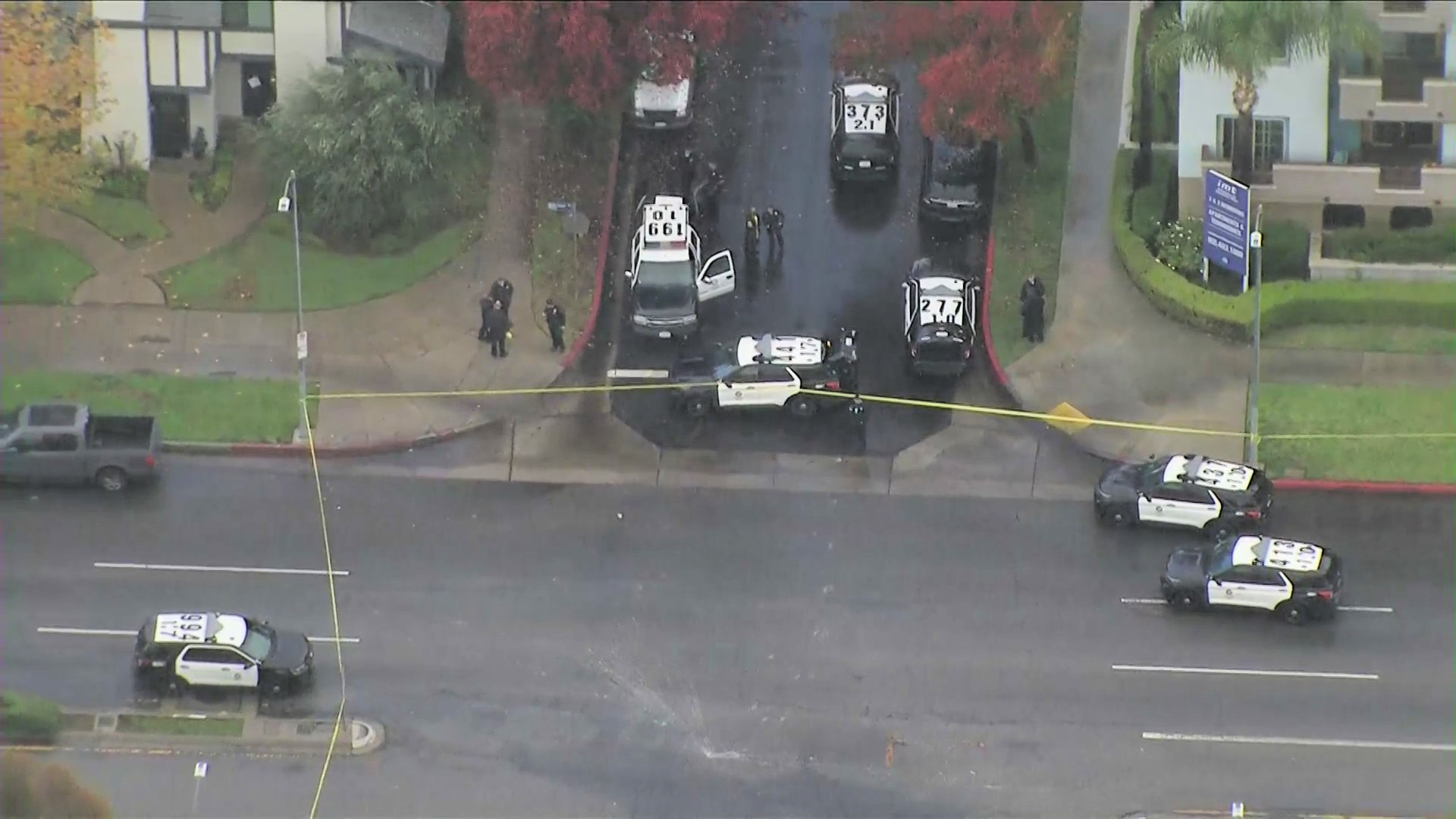 Police are seen at the scene of a shooting in Reseda on Dec. 24, 2021. (KTLA)