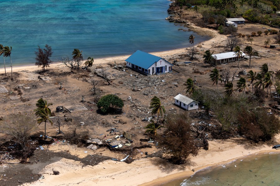 In this photo provided by the Australian Defence Force, debris from damaged building and trees are strewn around on Atata Island in Tonga, on Jan. 28, 2022, following the eruption of an underwater volcano and subsequent tsunami. (POIS Christopher Szumlanski/Australian Defence Force via AP, File)