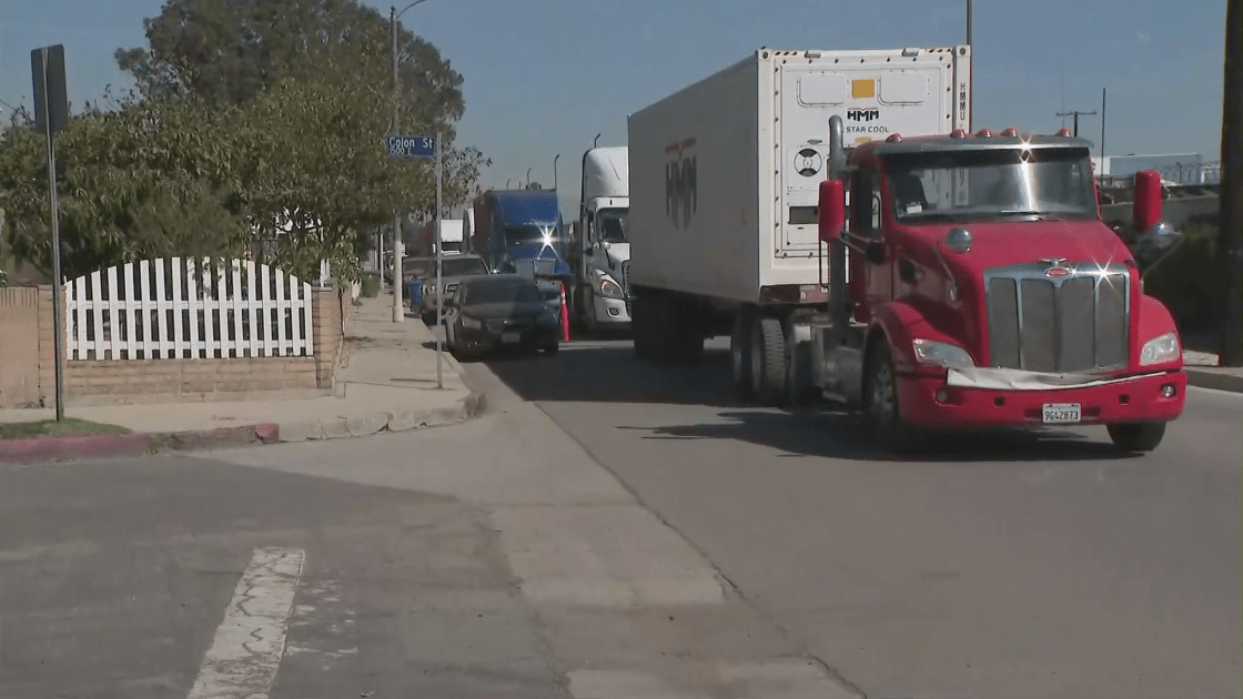 Big rigs line a narrow street in a Wilmington neighborhood on March 2, 2022. (KTLA)