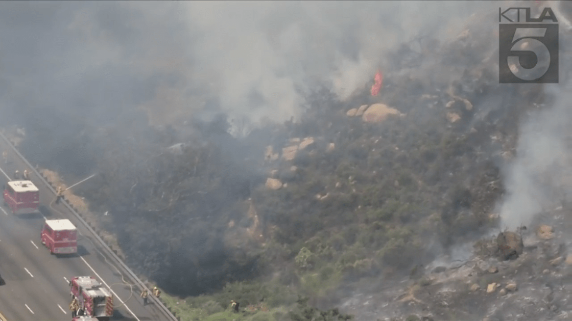 Crews battle a brush fire in Chatsworth on April 6, 2022. (KTLA)