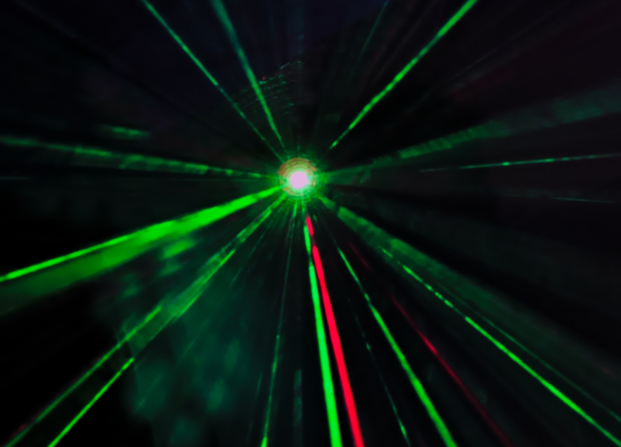 laser beams in green and red colors reflecting in the mist