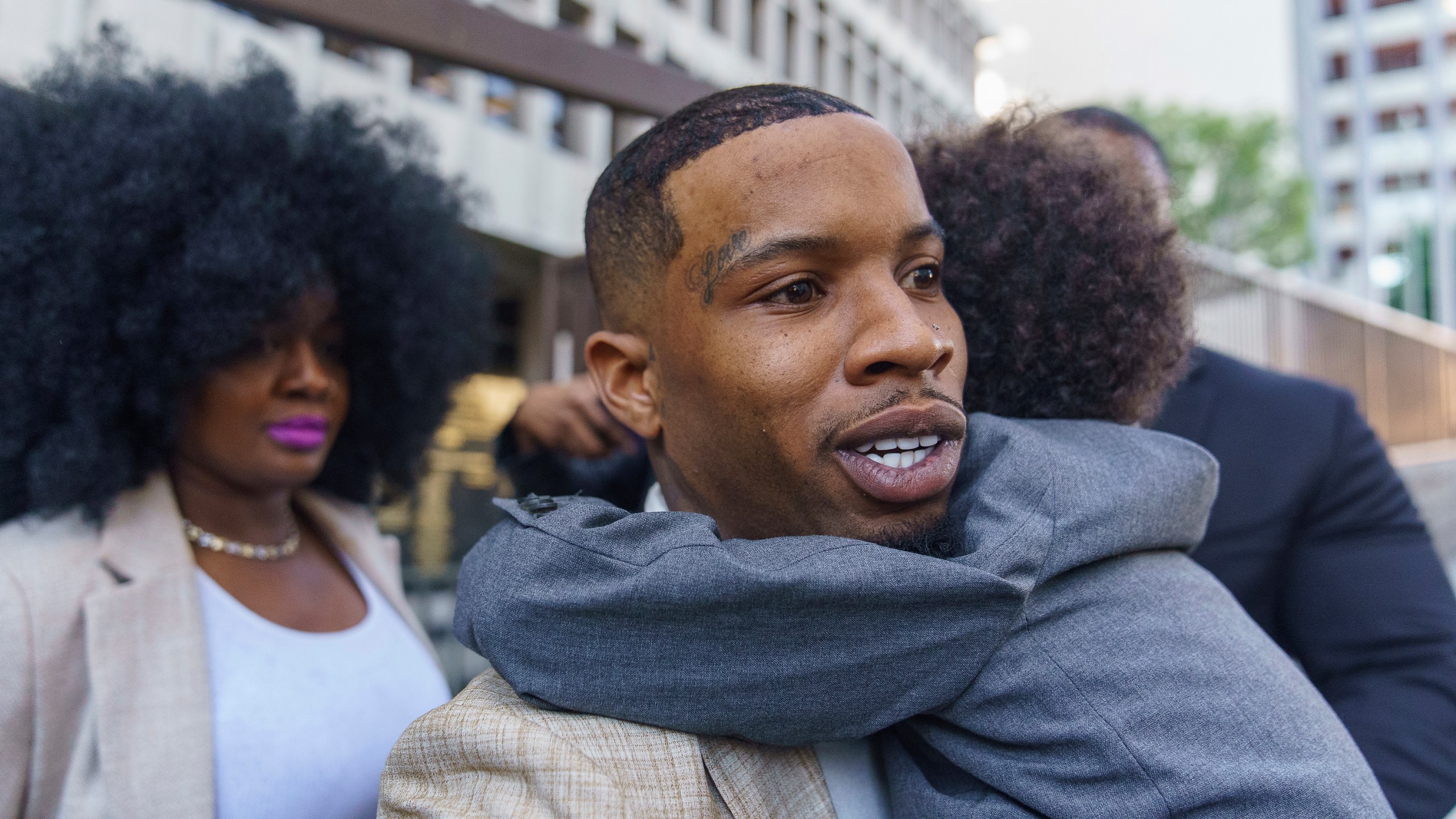 Rapper Tory Lanez, 30, walks out of a Los Angeles courthouse while holding his 5-year-old son Kai'Lon on Dec. 13, 2022. (Damian Dovarganes/Associated Press)