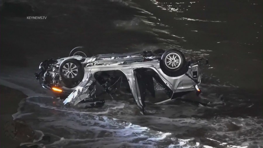 A driver allegedly under the influence smashed into parked cars along PCH on April 8, 2023, sending them careening toward pedestrians on the oceanside rocks below. (KeyNews.TV)
