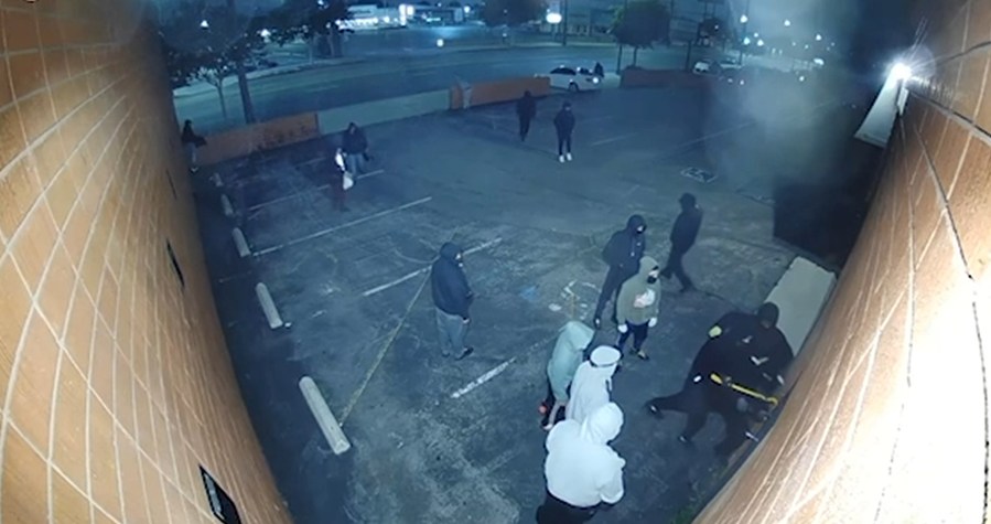 A still from video provided by F22 Studios shows a large group of men try and break into the production rental house in Burbank on May 10, 2023. 