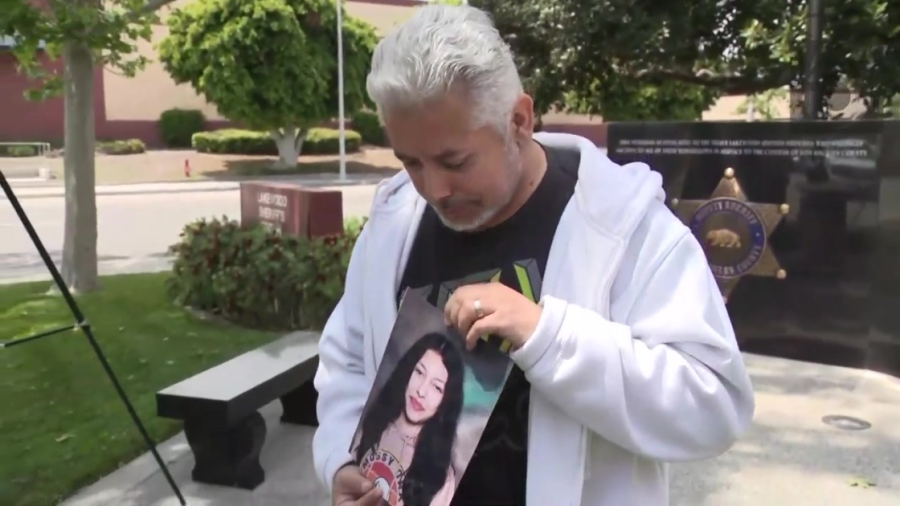 Gabriel Espinoza holds up a photo of his missing daughter, Jaqualine Ramos Espinoza, during a news conference on May 11, 2023. (KTLA)