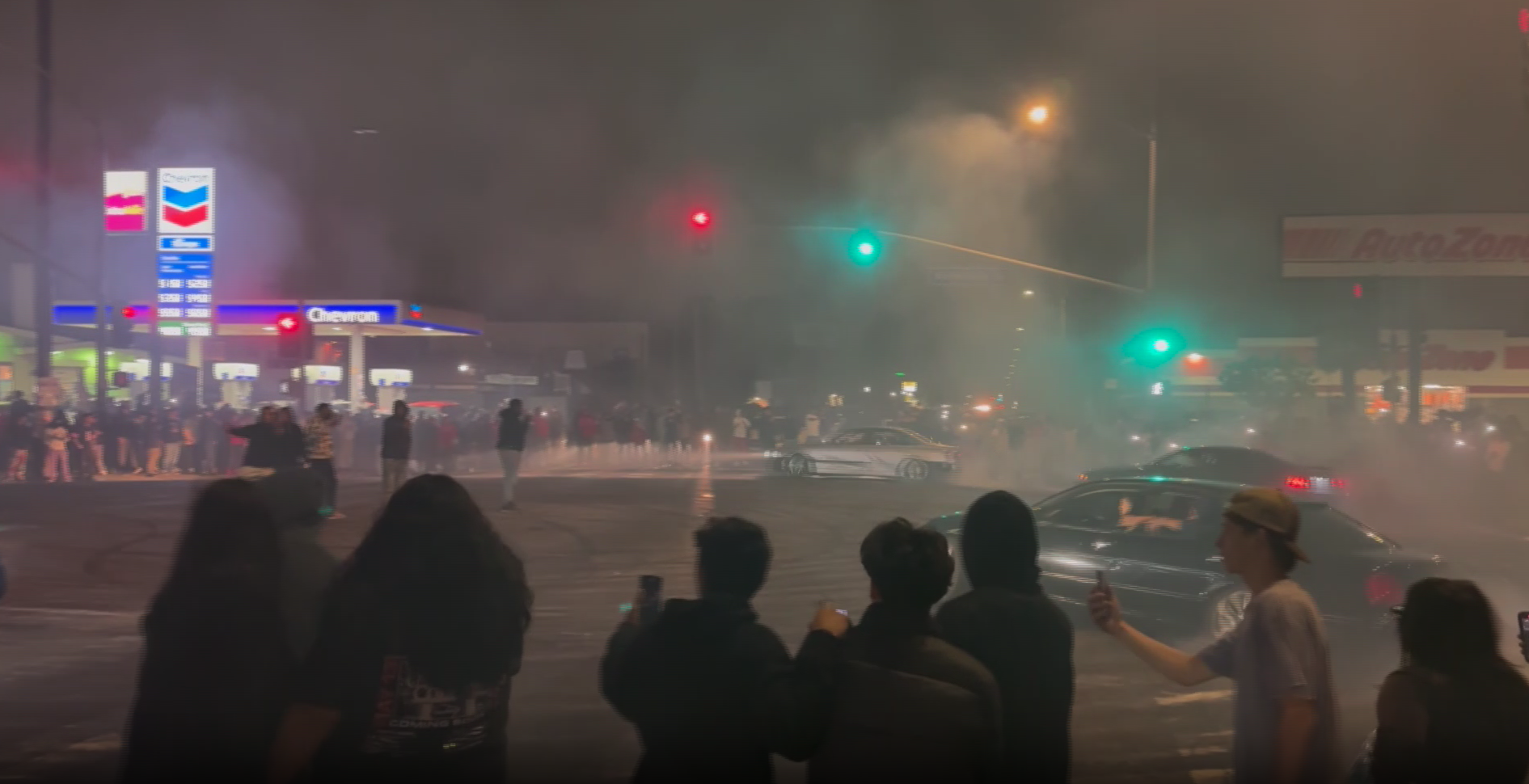 Video showed three cars and spectators involved in a street takeover on June 12, 2023.