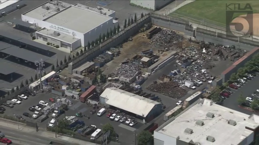 An aerial photo from Sky5 shows Jordan High School (left) next to Atlas Iron and Metal Corp. in Watts on June 21, 2023. (KTLA)