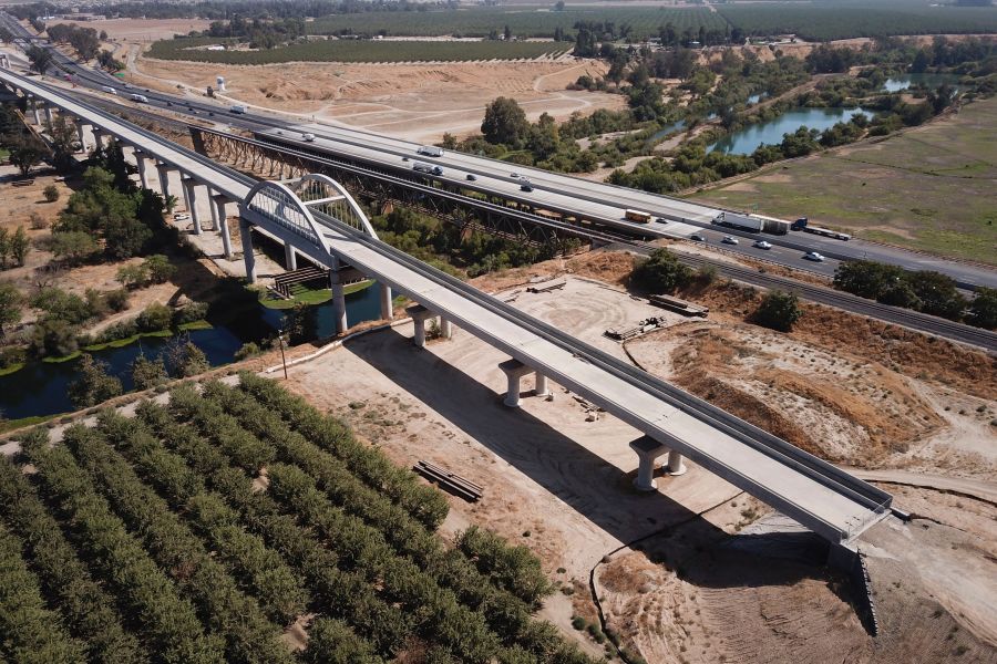 In this aerial image taken on August 26, 2021 vehicles drive past farmland and part of the California High Speed Rail Authority San Joaquin River viaduct construction project alongside US Highway 99 through the Central Valley between Madera County and Fresno County, California. - (Getty Images)