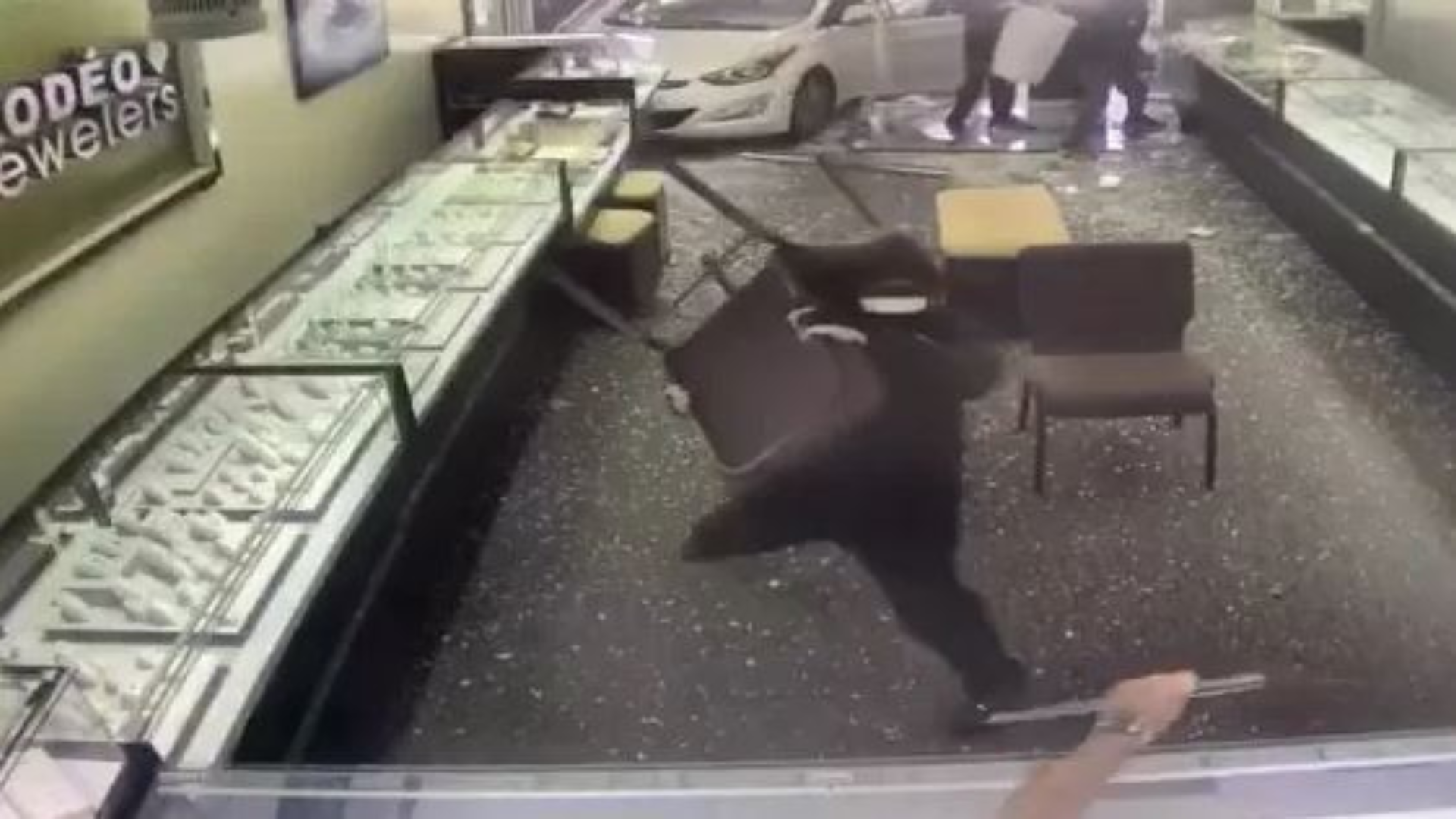 The thieves crashed through the front of the jewelry store with a car and began smashing display cases. July 1, 2023. (La Verne Police)