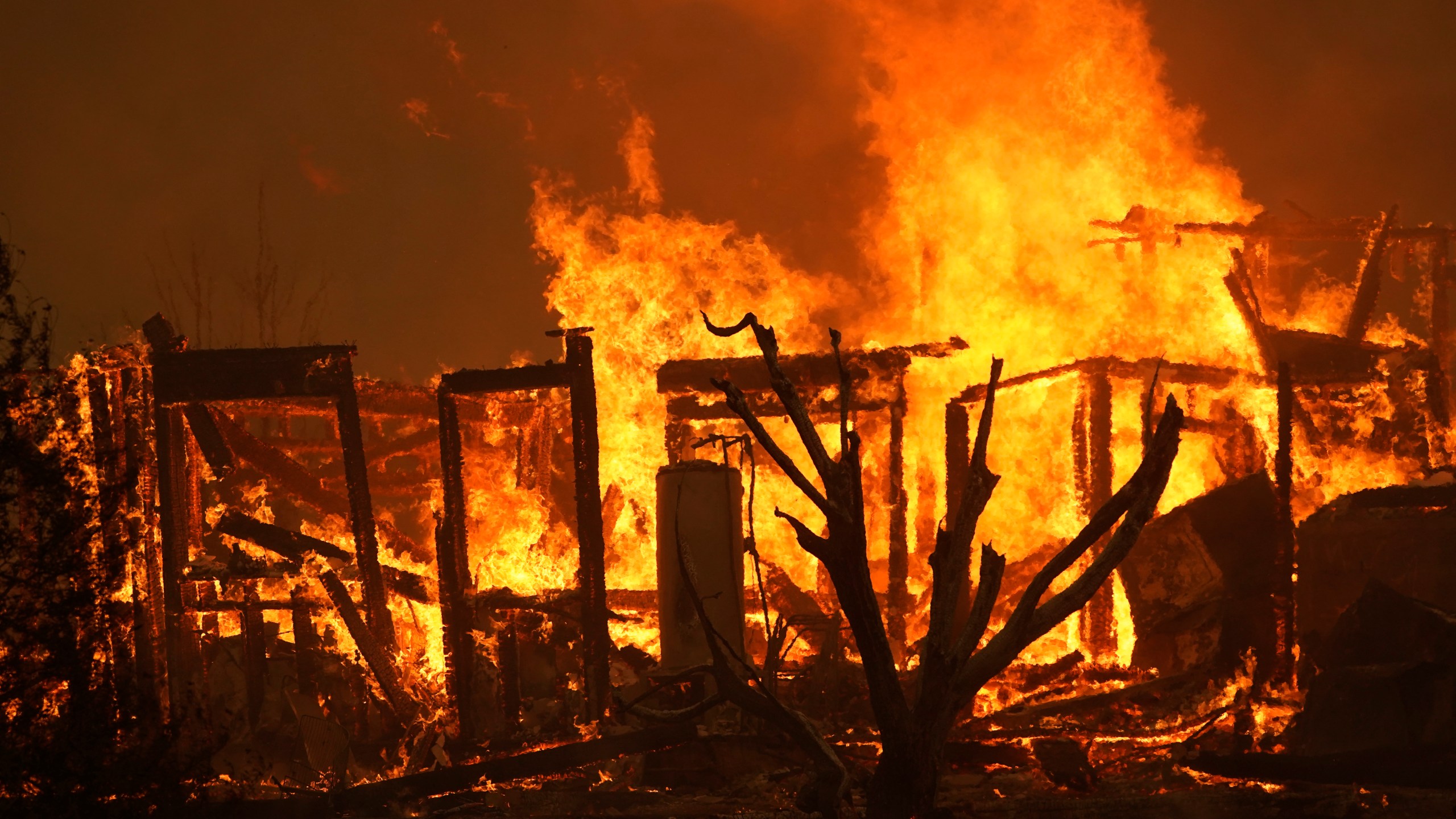 A home burns along Cima Mesa Rd. as the Bobcat Fire advances Friday, Sept. 18, 2020, in Juniper Hills, Calif. (AP Photo/Marcio Jose Sanchez)