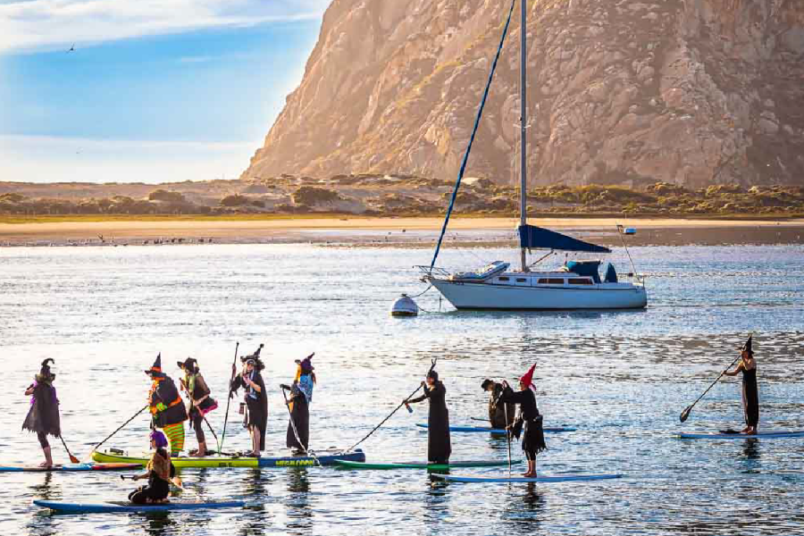 Paddleboarders and kayakers gathered in the waters of Morro Bay during the annual Witches and Warlocks Paddle. (John DeBacker)