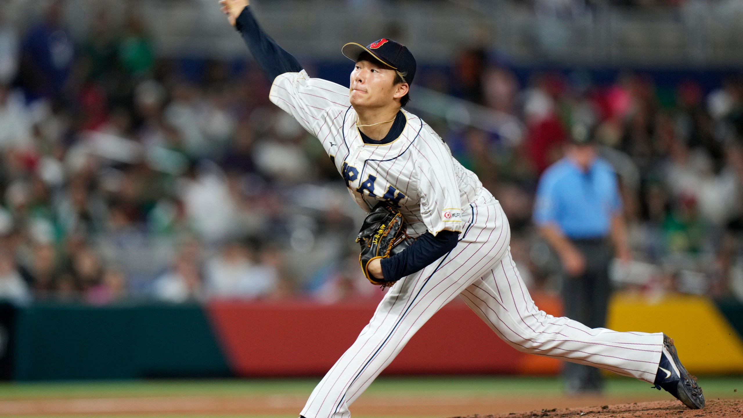 FILE - Japan's Yoshinobu Yamamoto delivers a pitch during the fifth inning of a World Baseball Classic game against Mexico on March 20, 2023, in Miami. Yamamoto, the most prized pitcher on the free-agent market, has agreed to a $325 million, 12-year contract with the Los Angeles Dodgers, according to multiple reports. (AP Photo/Wilfredo Lee, File)