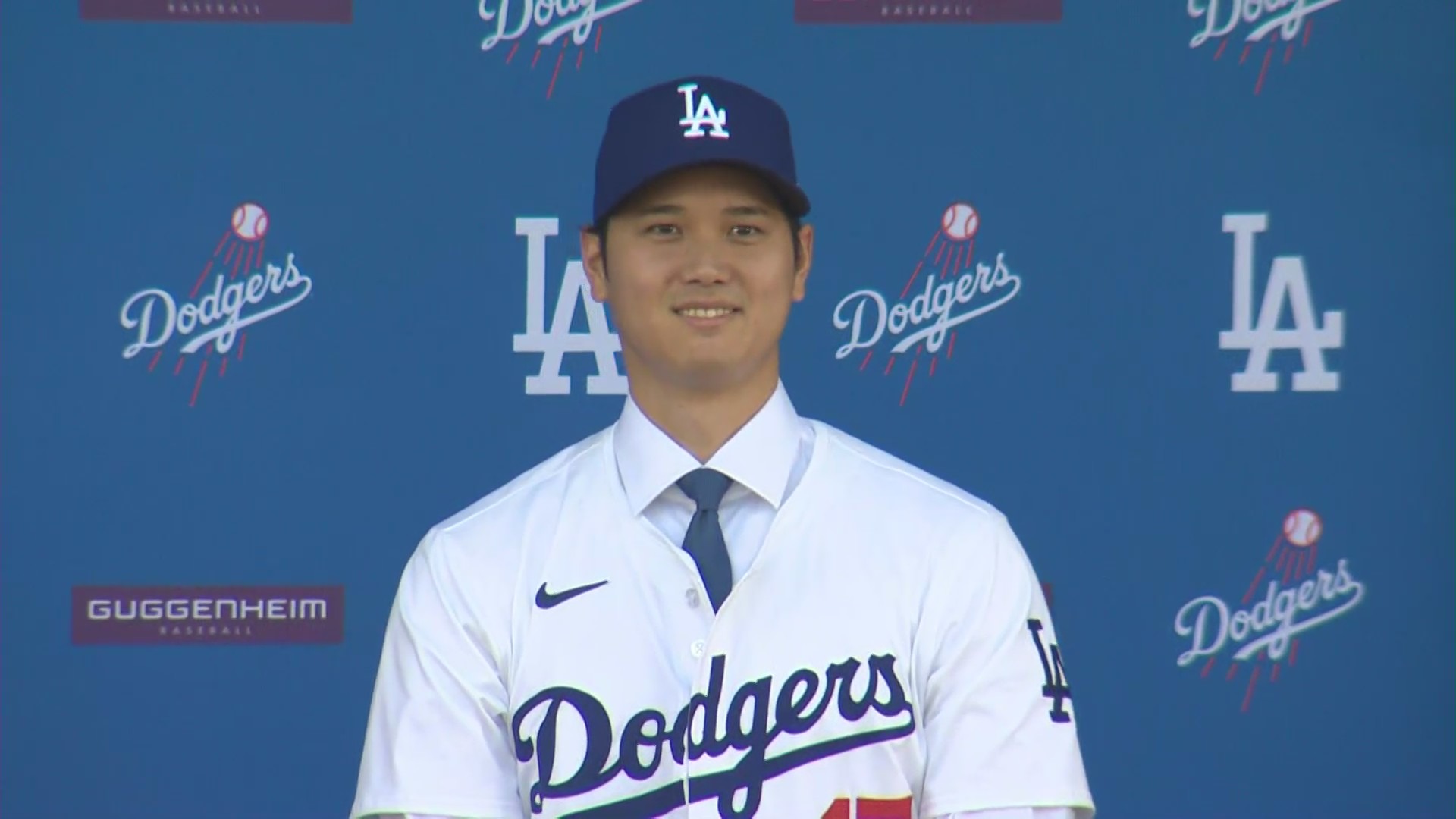 Shohei Ohtani stands at Dodger Stadium wearing his new jersey at his introductory press conference on Dec. 14, 2023. (KTLA)