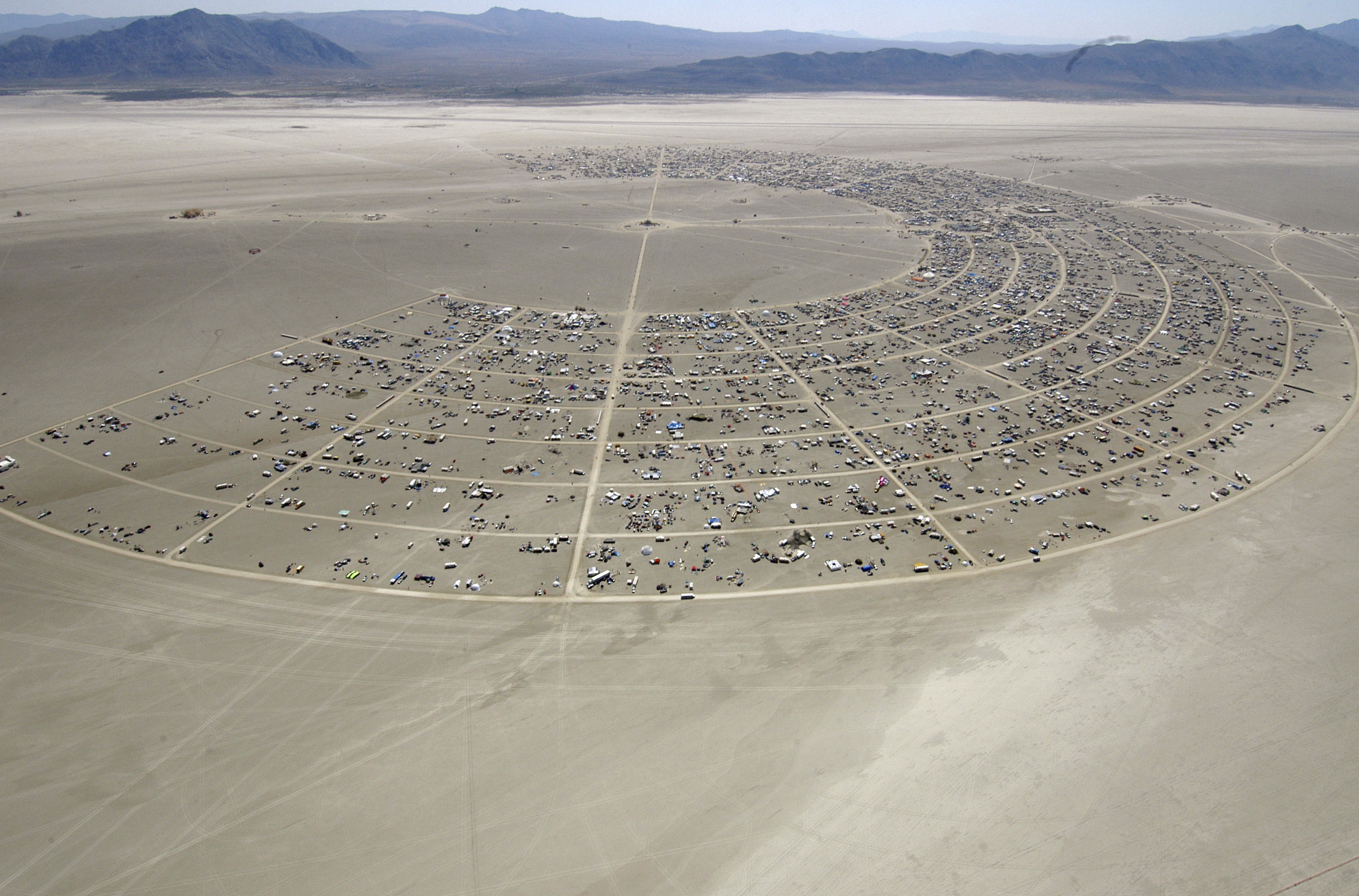 FILE - Black Rock City begins to grow during the opening of Burning Man Sunday, Aug. 27, 2006, in Gerlach, Nev. Burning Man organizers don't foresee major changes in 2024 thanks to a hard-won passing grade for cleaning up this year's festival. Despite the successful inspection, debate continues over whether the 30-year-old gathering has grown too big. Some question whether it has veered too far from its core principles of radical inclusion and participation. (AP Photo/Ron Lewis, File)
