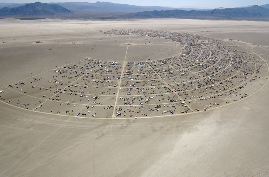 FILE - Black Rock City begins to grow during the opening of Burning Man Sunday, Aug. 27, 2006, in Gerlach, Nev. Burning Man organizers don't foresee major changes in 2024 thanks to a hard-won passing grade for cleaning up this year's festival. Despite the successful inspection, debate continues over whether the 30-year-old gathering has grown too big. Some question whether it has veered too far from its core principles of radical inclusion and participation. (AP Photo/Ron Lewis, File)