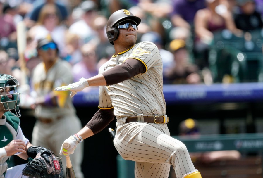 FILE - San Diego Padres' Juan Soto follows the flight of his two-run home run against Colorado Rockies starting pitcher Kyle Freeland in the third inning of a baseball game, Wednesday, Aug. 2, 2023, in Denver. Juan Soto, Vladimir Guerrero Jr. and Pete Alonso are among 194 players across Major League Baseball still negotiating salaries for the 2024 season leading into Thursday’s Jan. 11, 2024, deadline. (AP Photo/David Zalubowski, File)
