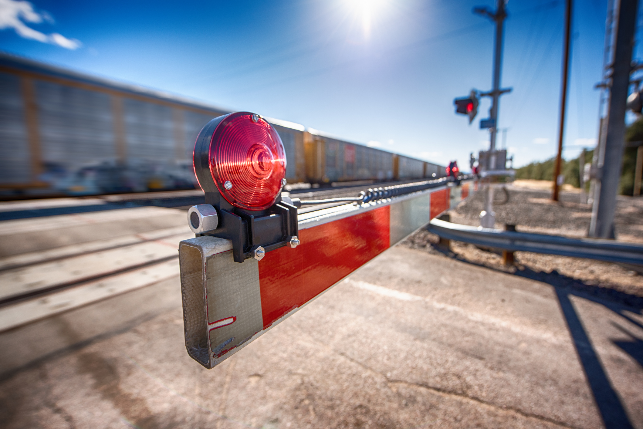 A railroad crossing with the gate closed as a freight train passes eastbound from Los Angeles through the Southern California desert at Kelso Junction located in the Mojave Desert in eastern San Bernardino County, California. (Getty Images)