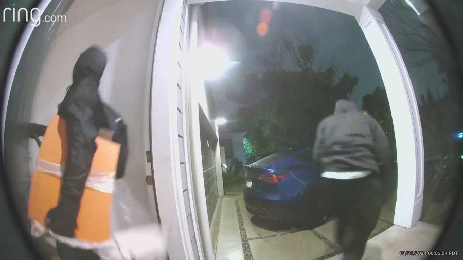 Burglars running out the front door after stealing items from a Westchester home.
