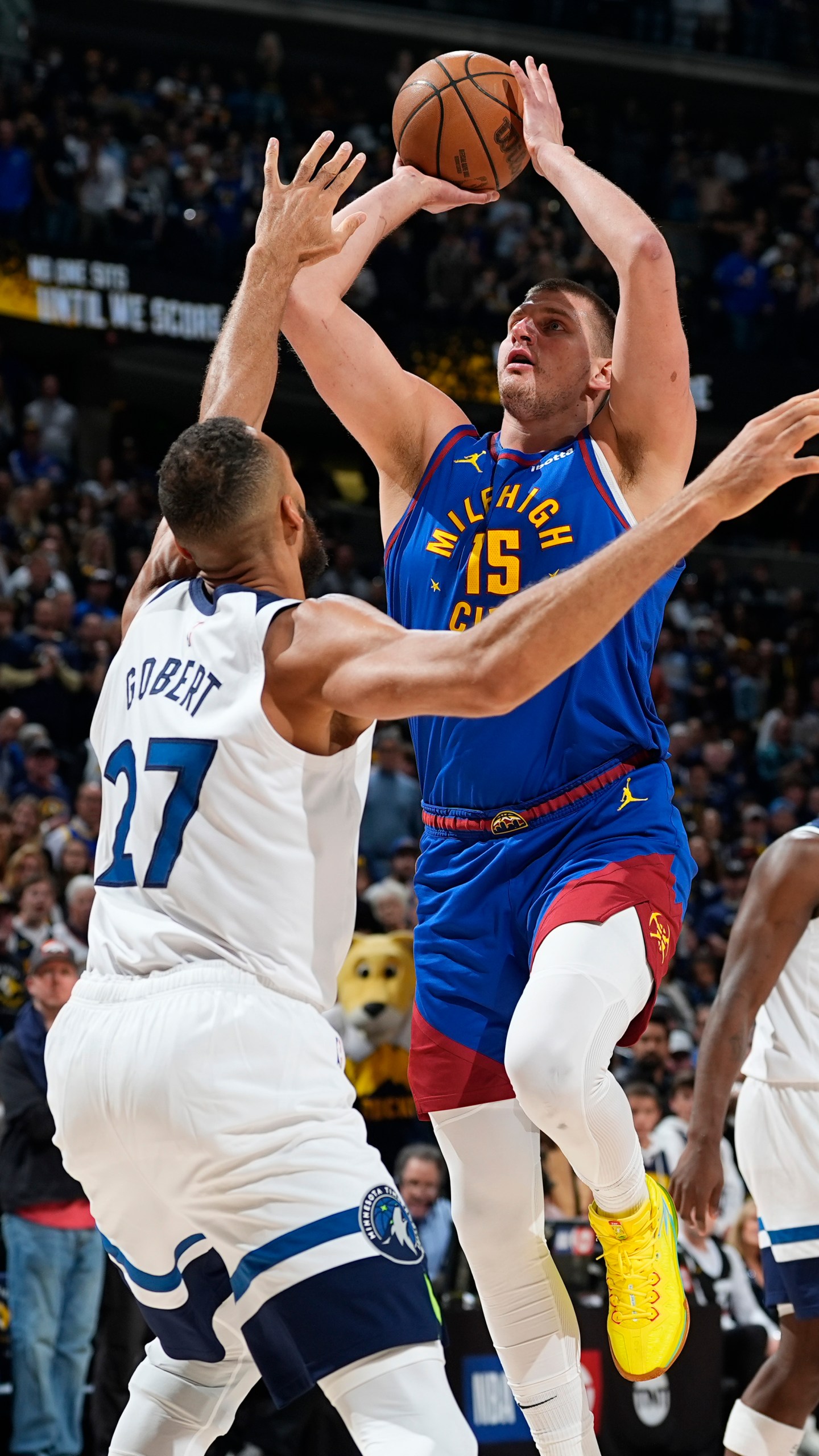 Denver Nuggets center Nikola Jokic, right, goes up for a basket over Minnesota Timberwolves center Rudy Gobert in the first half of Game 1 of an NBA basketball second-round playoff series Saturday, May 4, 2024, in Denver. (AP Photo/David Zalubowski)