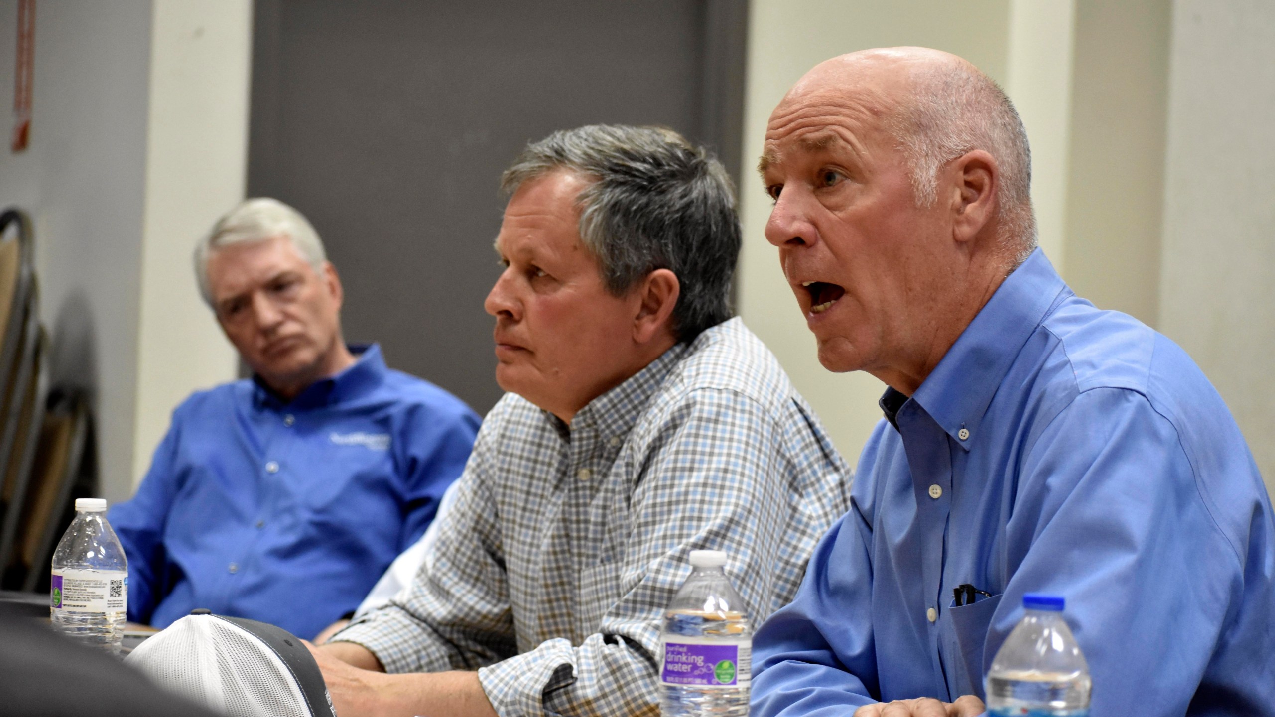 Montana Republican Gov. Greg Gianforte, right, talks about Biden administration policies impacting the coal industry as Republican Sen. Steve Daines, center, and NorthWestern Energy President Brian Bird look on during a roundtable meeting with coal executives and local officials at the Rosebud mine, on Tuesday, May 28, 2024, in Colstrip, Mont. Gianforte said electricity prices could go up because of the Democratic administration's policies. (AP Photo/Matthew Brown)