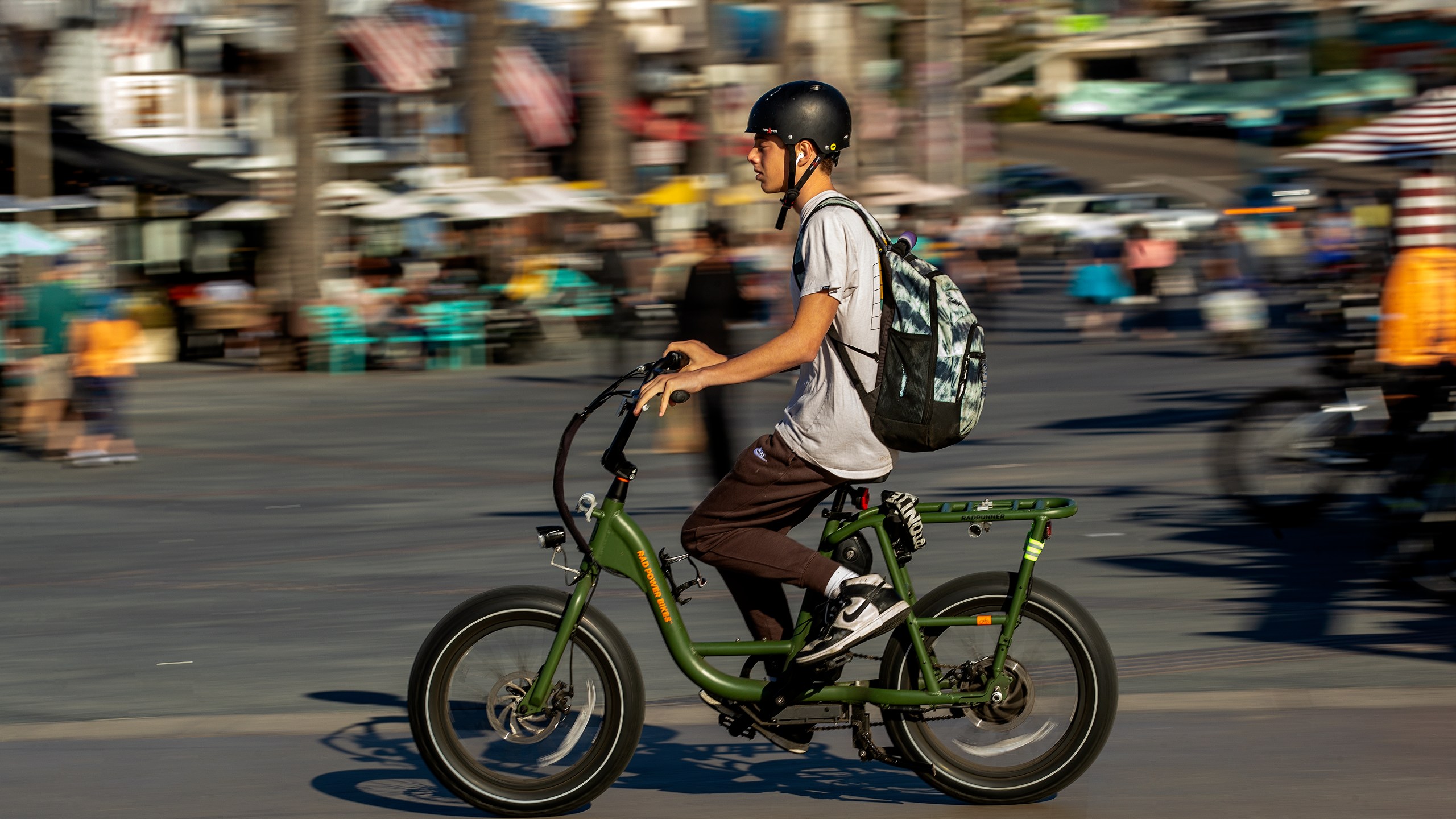 A person rides his e-bike on the Strand in Hermosa Beach. In Hermosa Beach, it's against city code to use electric power on the Strand, but many e-bike riders do so anyway. (Mel Melcon / Los Angeles Times via Getty Images)
