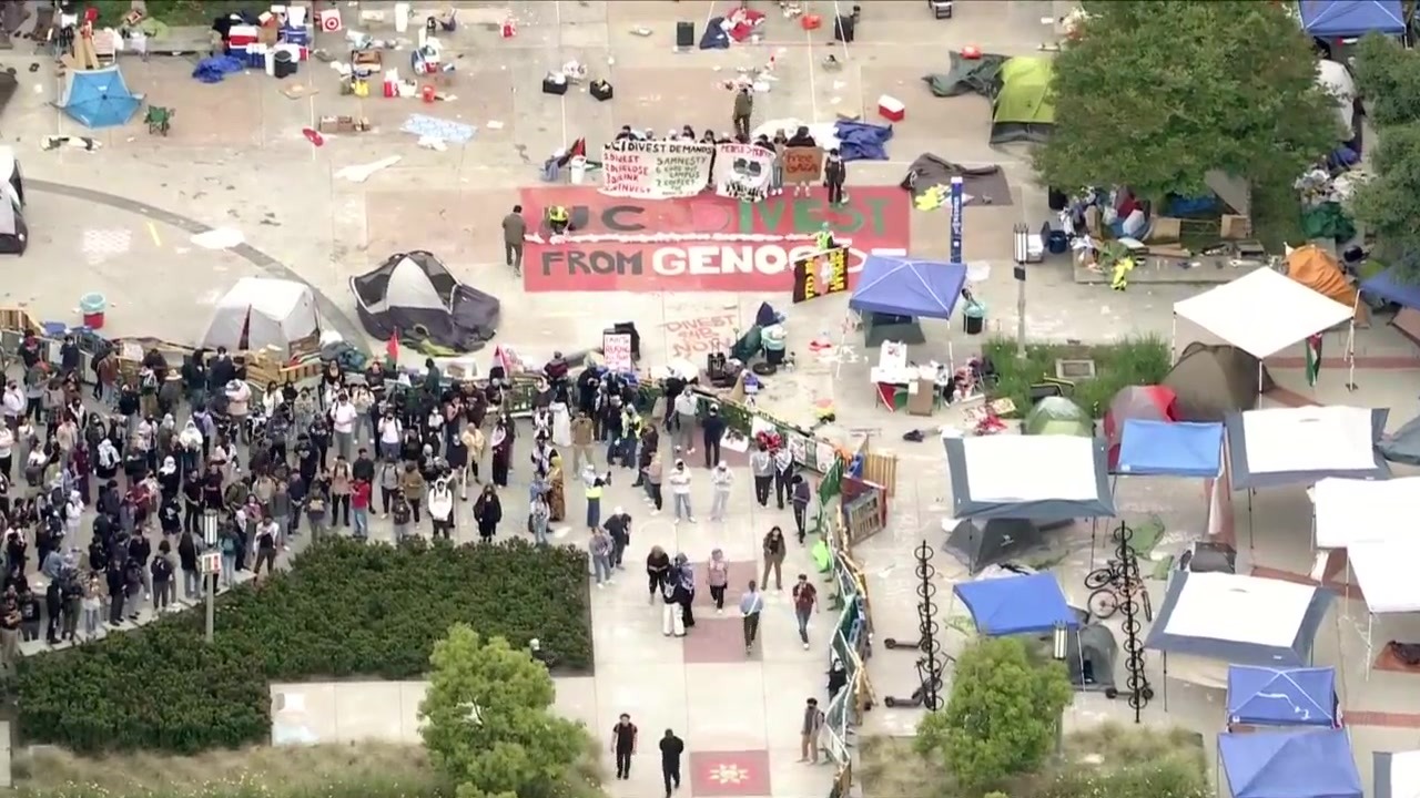 Law enforcement officers are seen approaching a protest encampment at UC Irvine on May 15, 2024. (KTLA)