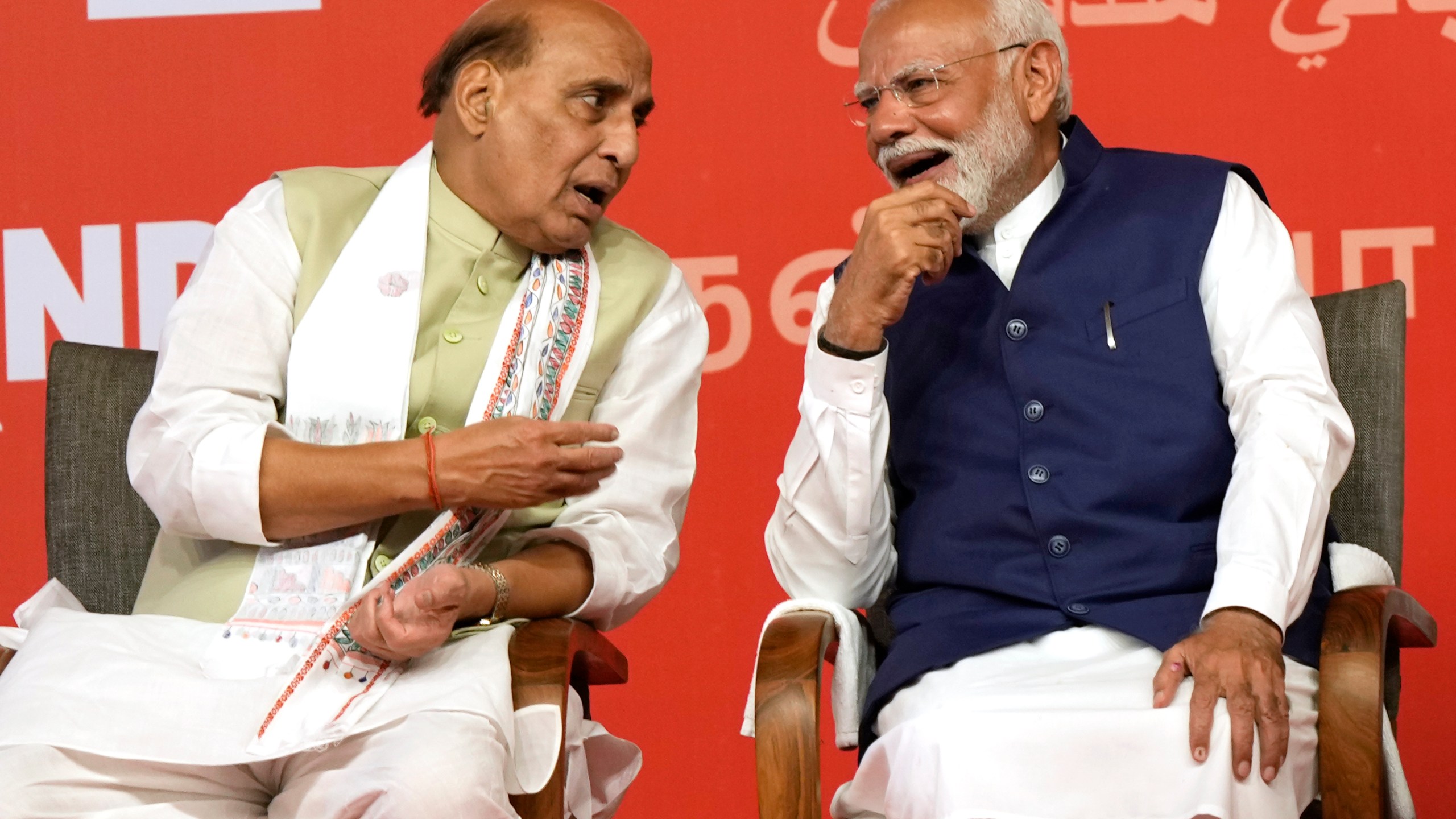Prime Minister Narendra Modi, right, chats with Defense Minister Rajnath Singh before addressing supporters at the Bharatiya Janata Party (BJP) headquarters, in New Delhi, India, Tuesday, June 4, 2024. (AP Photo/Manish Swarup)
