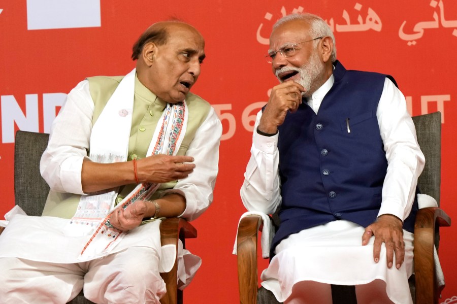 Prime Minister Narendra Modi, right, chats with Defense Minister Rajnath Singh before addressing supporters at the Bharatiya Janata Party (BJP) headquarters, in New Delhi, India, Tuesday, June 4, 2024. (AP Photo/Manish Swarup)