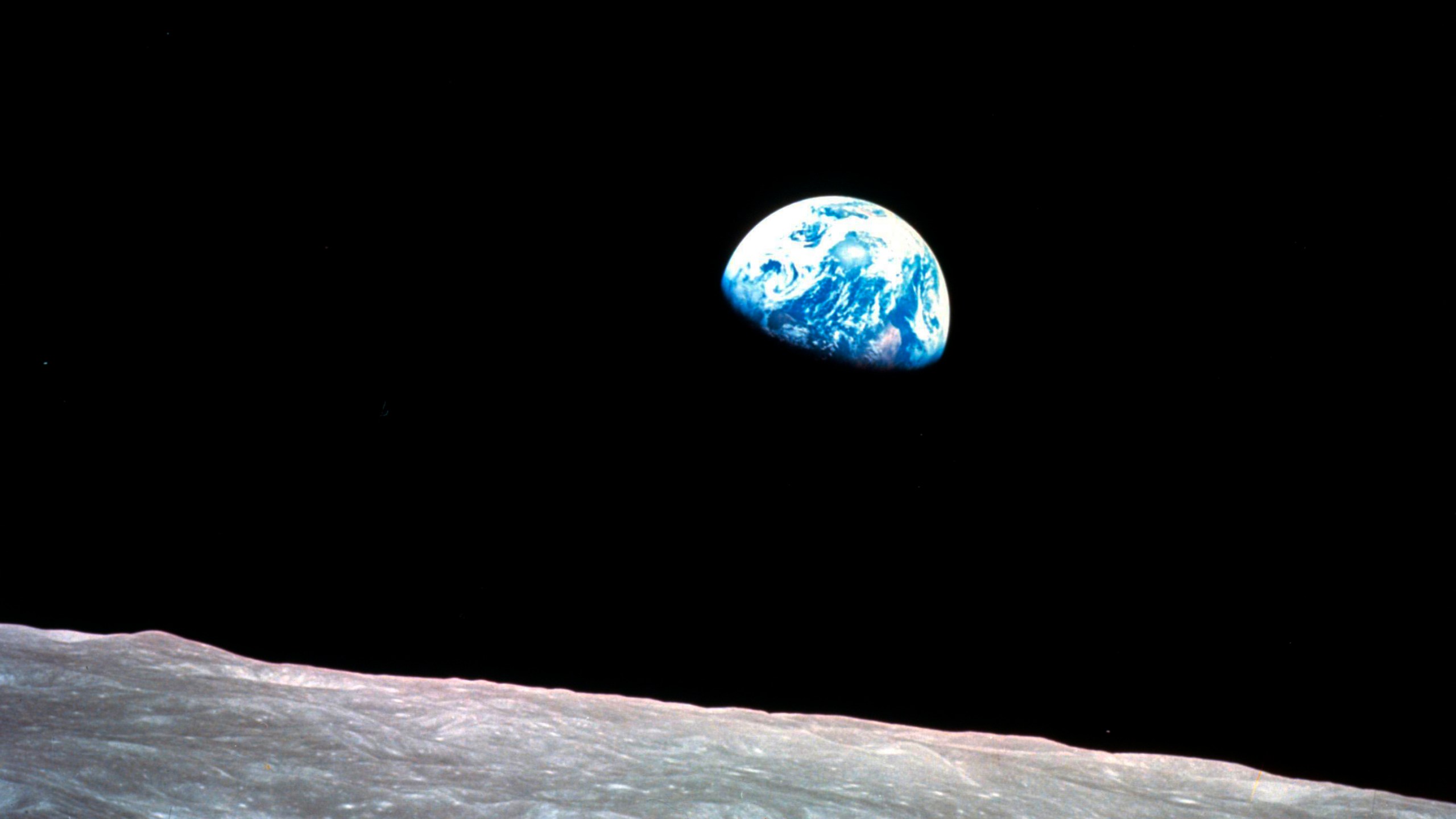FILE - This Dec. 24, 1968, file photo made available by NASA shows the Earth behind the surface of the moon during the Apollo 8 mission. Retired Maj. Gen. William Anders, the former Apollo 8 astronaut who took the iconic “Earthrise” photo showing the planet as a shadowed blue marble from space in 1968, was killed Friday, June 7, 2024, when the plane he was piloting alone plummeted into the waters off the San Juan Islands in Washington state. He was 90. (William Anders/NASA via AP, File)