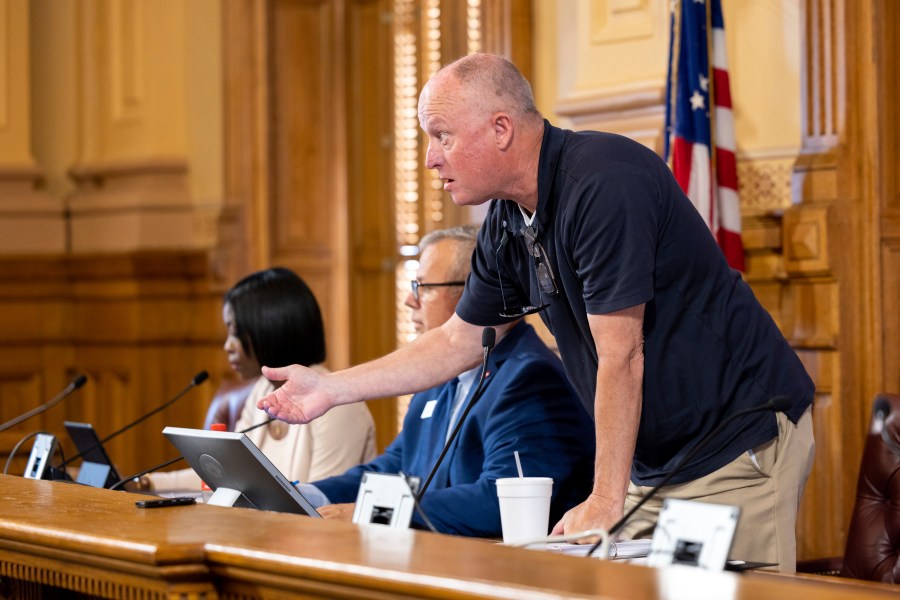 FILE - State Election Board member Rick Jeffares asks the crowd to settle down during a hastily planned State Election Board meeting at the Capitol in Atlanta on Friday, July 12, 2024. The Georgia State Election Board, which once toiled in relative obscurity, now hosts raucous meetings where public comment spans several hours and attendees regularly heckle its members. (Arvin Temkar/Atlanta Journal-Constitution via AP, File)