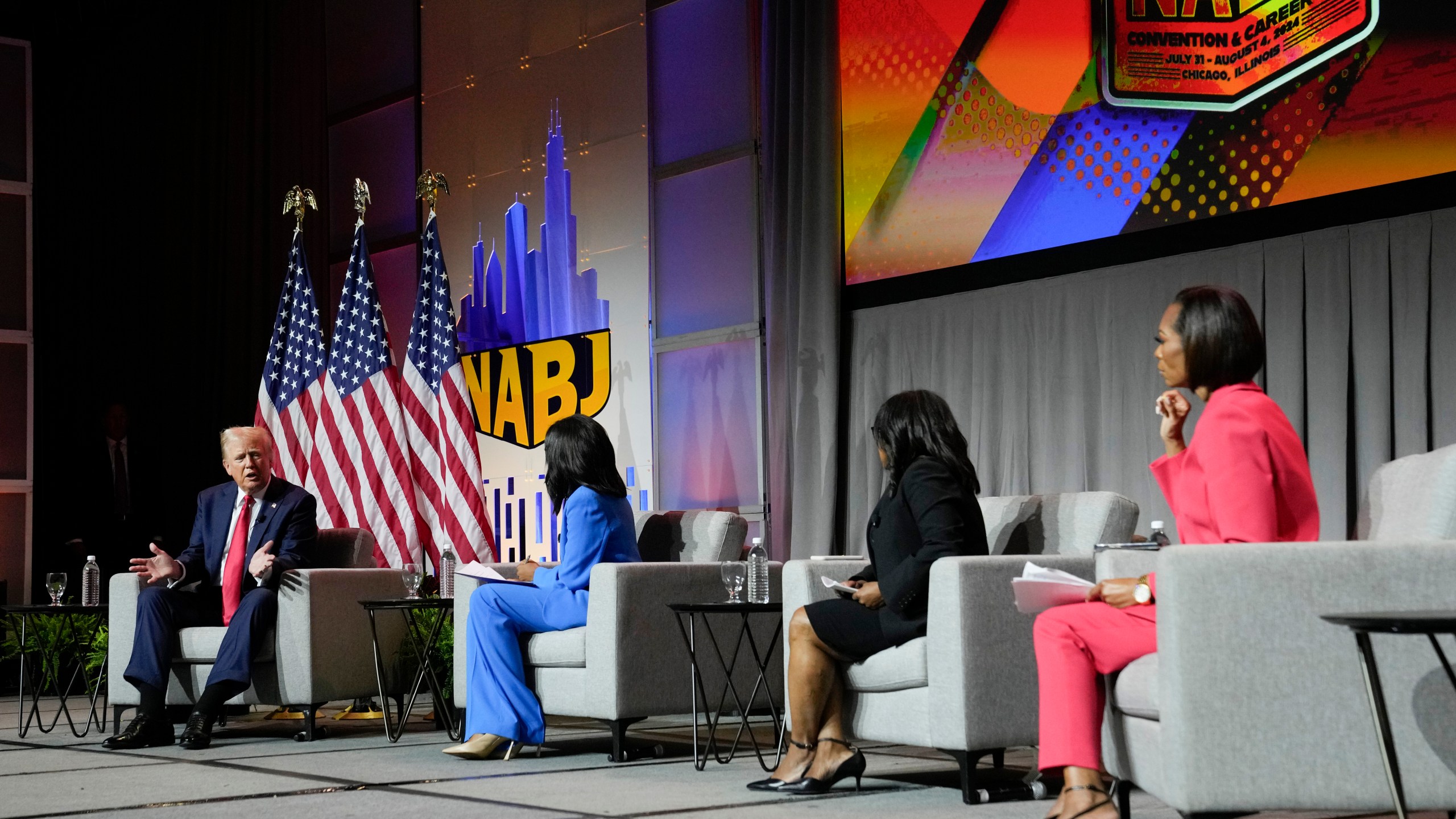 Republican presidential candidate former President Donald Trump, left, moderated by from left, ABC's Rachel Scott, Semafor's Nadia Goba and FOX News' Harris Faulkner, speaks at the National Association of Black Journalists, NABJ, convention, Wednesday, July 31, 2024, in Chicago. (AP Photo/Charles Rex Arbogast)