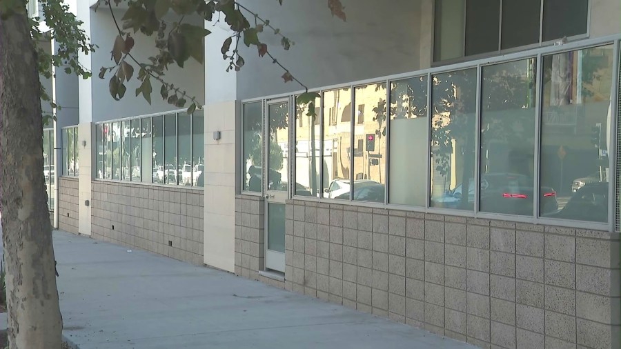 The glass barrier of the patio areas leading to first-floor residences at the WREN Apartments complex in downtown Los Angeles. (KTLA)