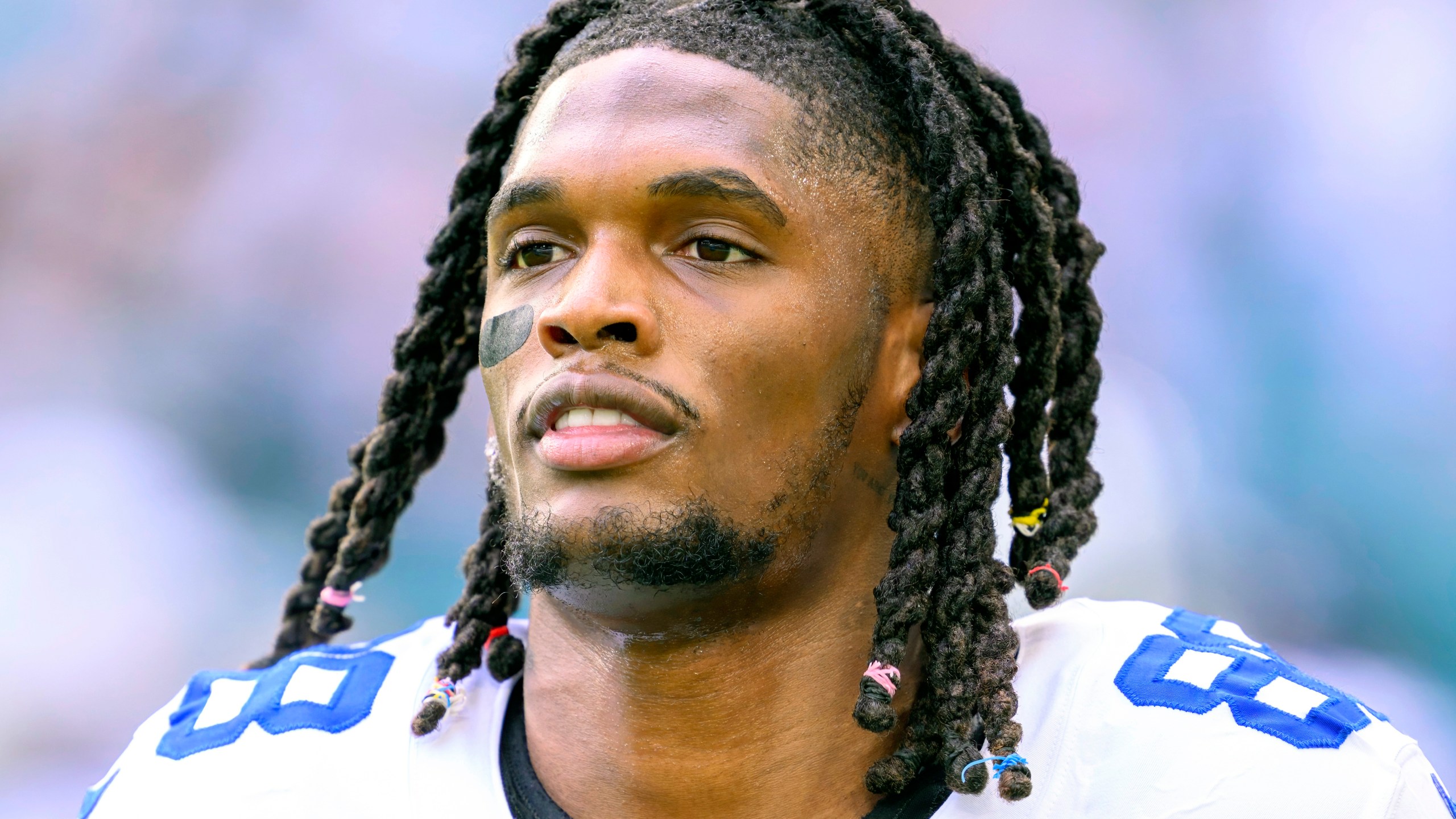 FILE - Dallas Cowboys wide receiver CeeDee Lamb (88) runs on the field before an NFL football game against the Miami Dolphins, Dec 24, 2023, in Miami Gardens, Fla. CeeDee Lamb is not reporting to training camp while he waits for a new contract, a person familiar with the All-Pro wide receiver’s decision told The Associated Press on Wednesday, July 24, 2024. (AP Photo/Doug Murray, File)