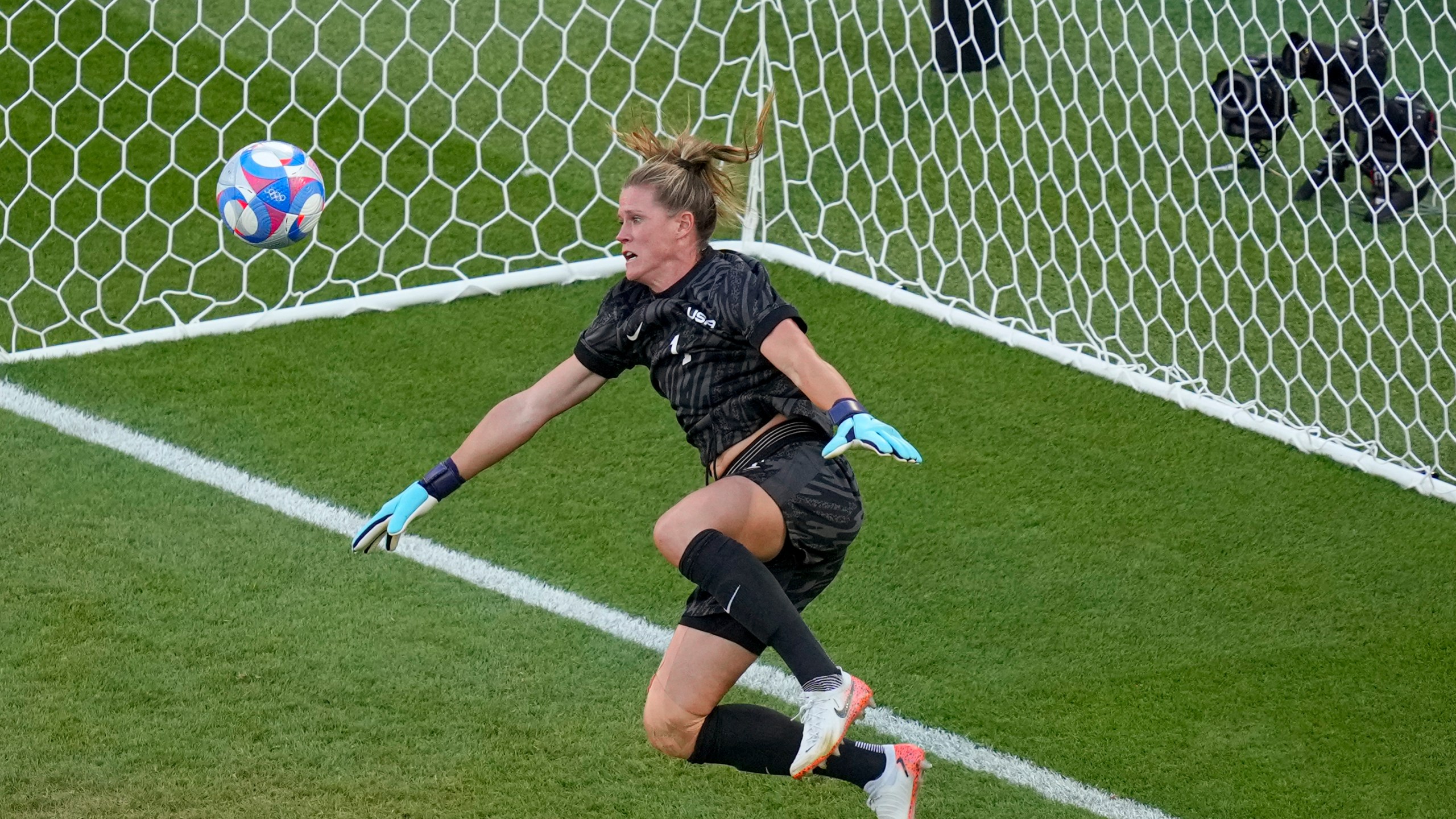 Goalkeeper Alyssa Naeher, of the United States saves a header by Brazil's Adriana during the women's soccer gold medal match between Brazil and the United States at the Parc des Princes during the 2024 Summer Olympics, Saturday, Aug. 10, 2024, in Paris, France. (AP Photo/Vadim Ghirda)