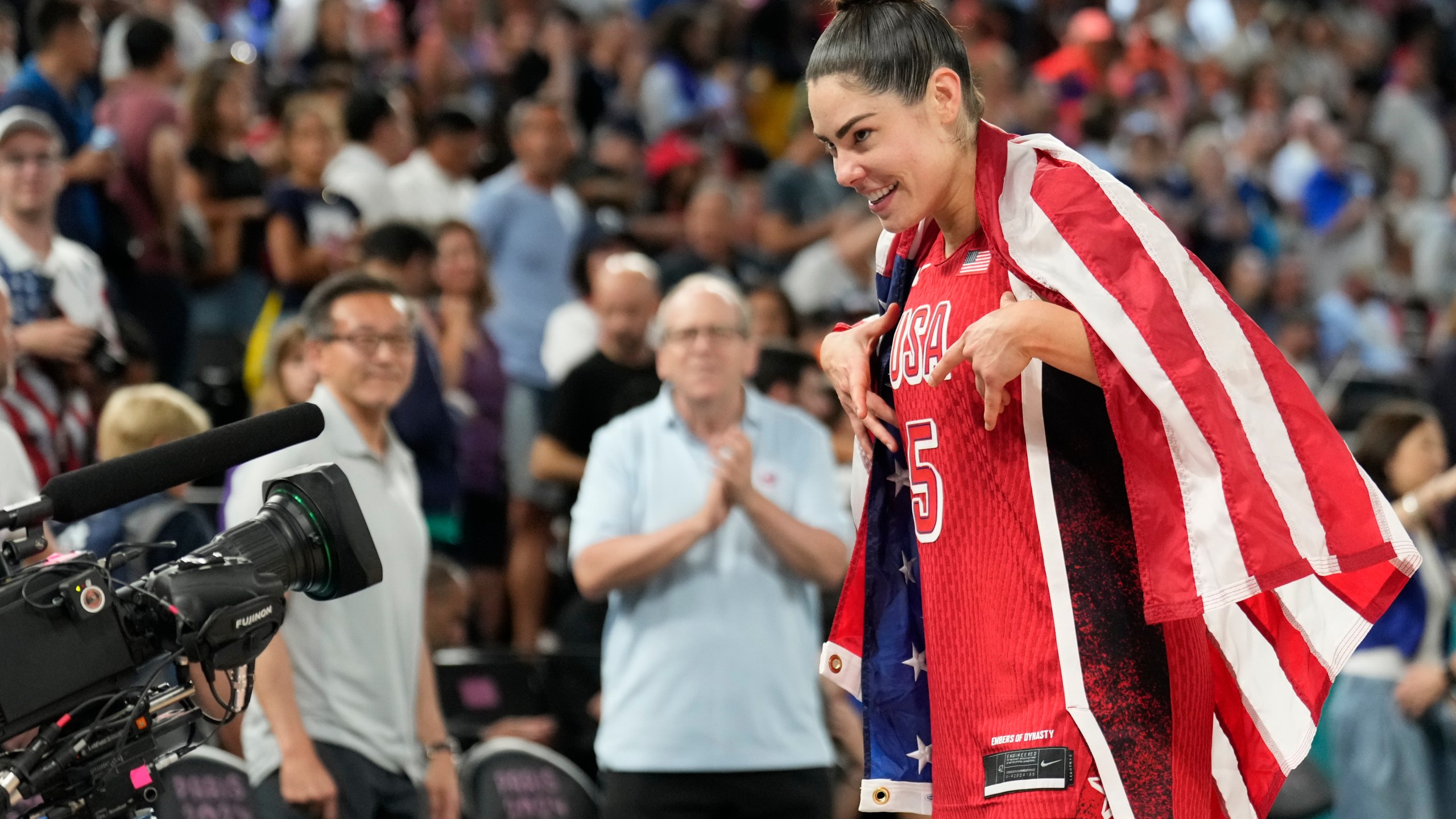 United States' Kelsey Plum (5) celebrates after a women's gold medal basketball game at Bercy Arena at the 2024 Summer Olympics, Sunday, Aug. 11, 2024, in Paris, France. (AP Photo/Mark J. Terrill)