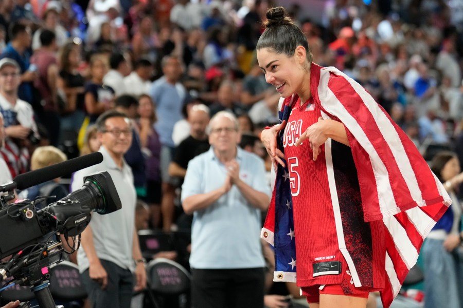 United States' Kelsey Plum (5) celebrates after a women's gold medal basketball game at Bercy Arena at the 2024 Summer Olympics, Sunday, Aug. 11, 2024, in Paris, France. (AP Photo/Mark J. Terrill)