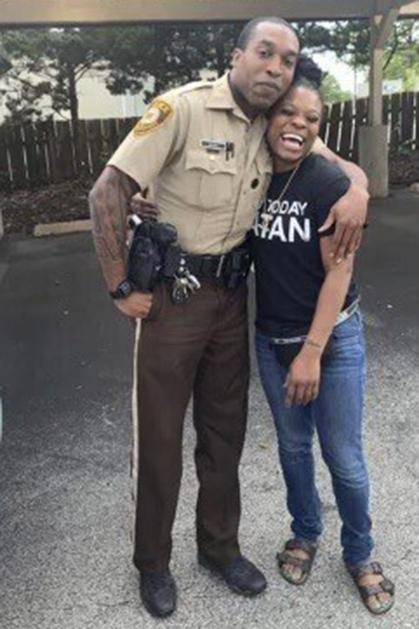 In this undated photo provided by Charlene Jefferson in August 2024, Travis Brown, when he was St. Louis County police officer, stands with Danielle Oliver. Brown, a Ferguson Police officer, suffered a severe brain injury after he was knocked to the ground Friday, Aug. 9, 2024, during a protest in Ferguson, Mo., on the 10th anniversary of the shooting death of Michael Brown. (Charlene Jefferson via AP)