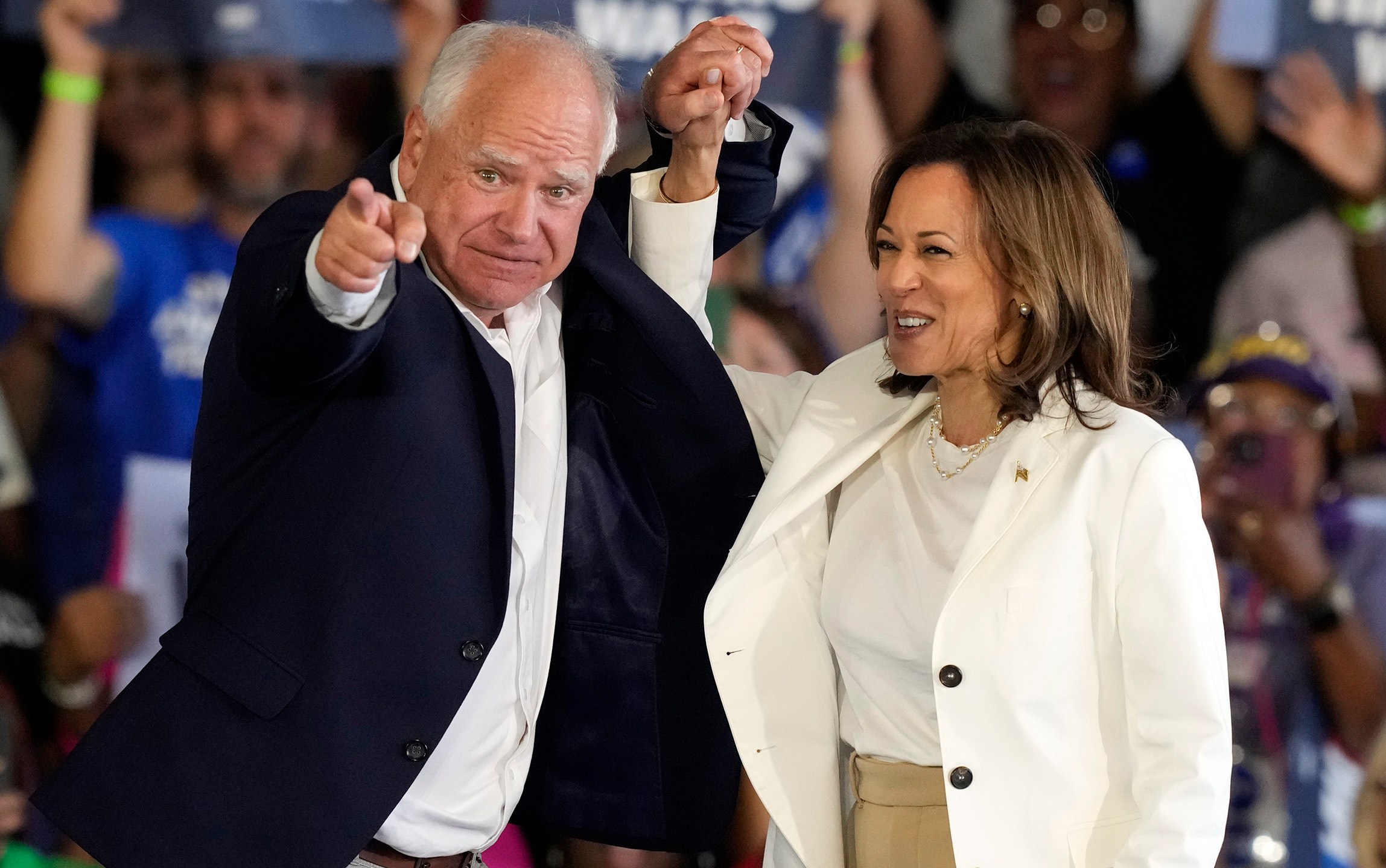 Democratic presidential nominee Vice President Kamala Harris and running mate Minnesota Gov. Tim Walz arrive at a campaign rally Wednesday, Aug. 7, 2024, in Romulus, Mich. (AP Photo/Carlos Osorio)