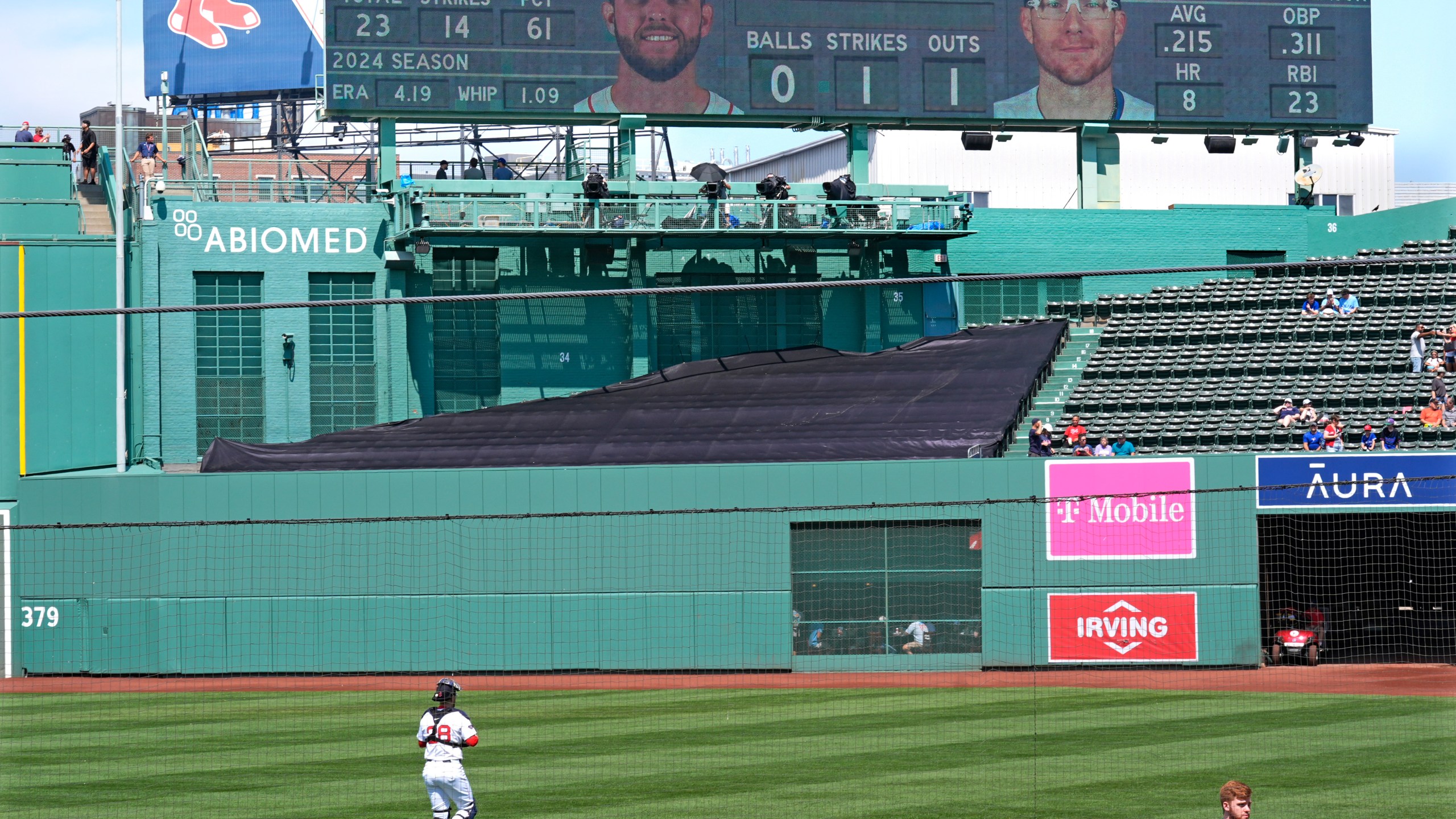 Boston Red Sox catcher Danny Jansen heads to the bullpen to prior baseball game, which was delayed due to rain in June, against the Toronto Blue Jays at Fenway Park, Monday, Aug. 26, 2024, in Boston. Jansen, who was traded by the Blue Jays to the Red Sox on July 27th, is in the line-up against his former team when the delayed game continues Monday afternoon. Jansen will become the first major league player to appear in the same game for both teams. (AP Photo/Charles Krupa)