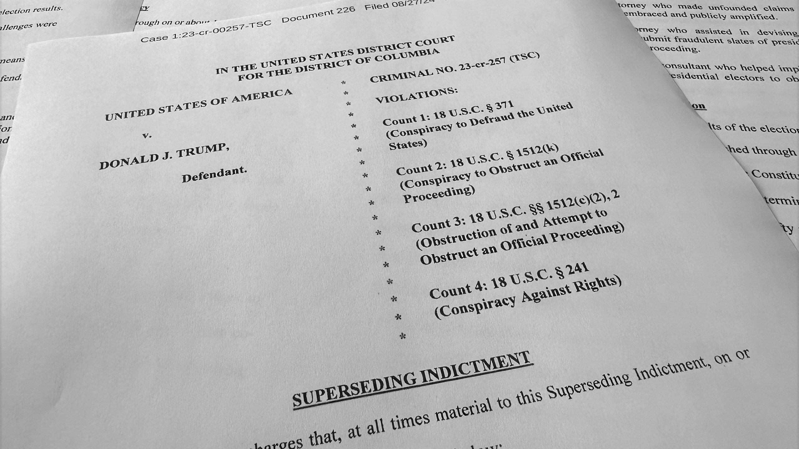 The superseding indictment against former President Donald Trump is photographed Tuesday, Aug. 27, 2024, after special counsel Jack Smith filed the new indictment against Trump that keeps the same criminal charges but narrows the allegations against him following a Supreme Court opinion conferring broad immunity on former presidents. (AP Photo/Jon Elswick)