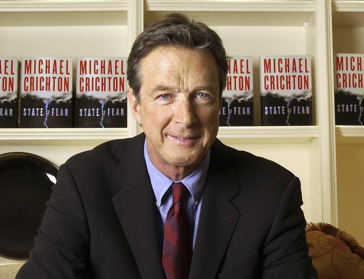 FILE - Author Michael Crichton poses for a portrait at The Peninsula Hotel in New York on Dec. 7, 2004. (AP Photo/Jim Cooper, File)